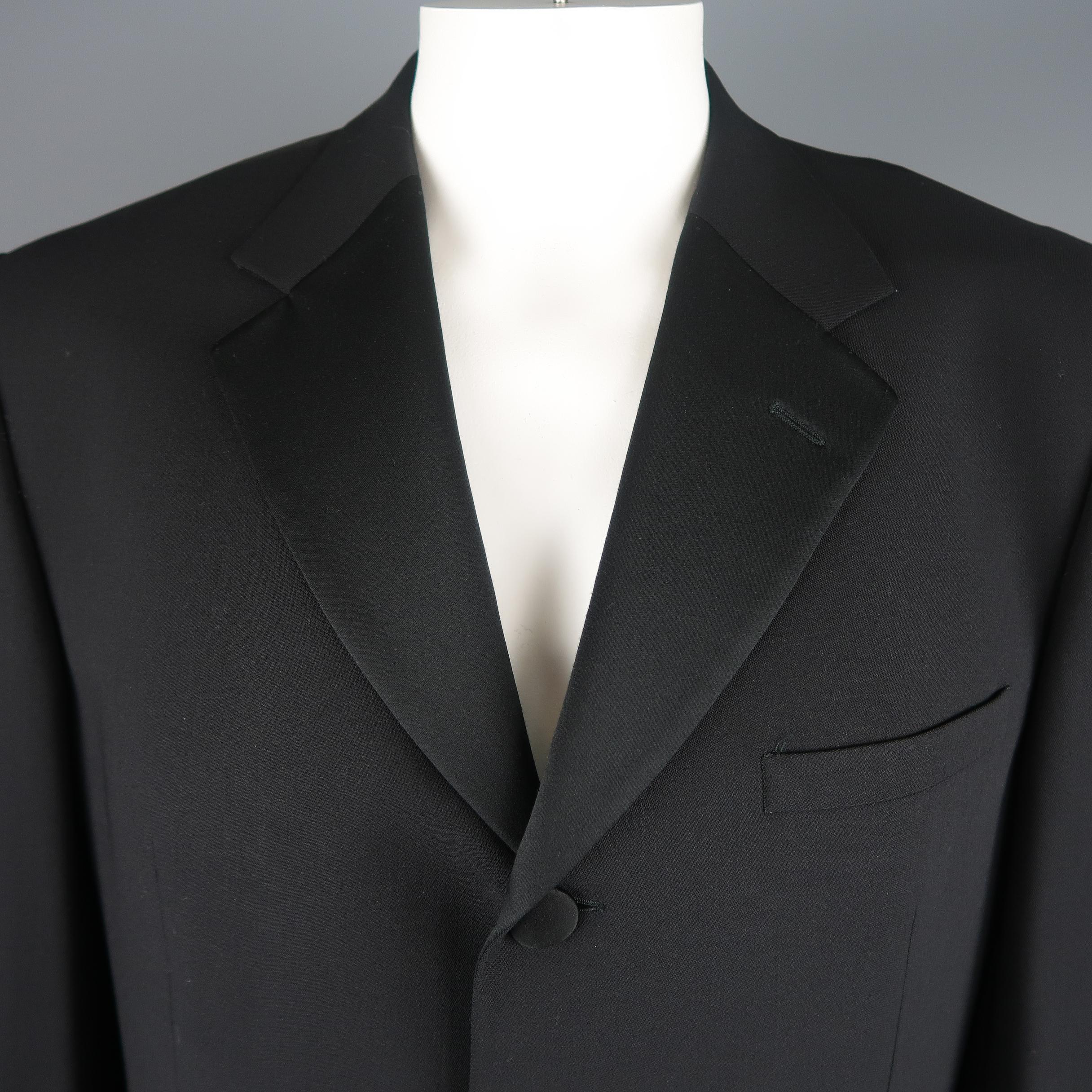 Single breasted V2 CLASSIC by VERSACE sport coat tuxedo jacket comes in black wool blend fabric with a half satin notch lapel, four button front with satin buttons, and short vented back. Made in Italy.
 
Excellent Pre-Owned Condition.
Marked: IT