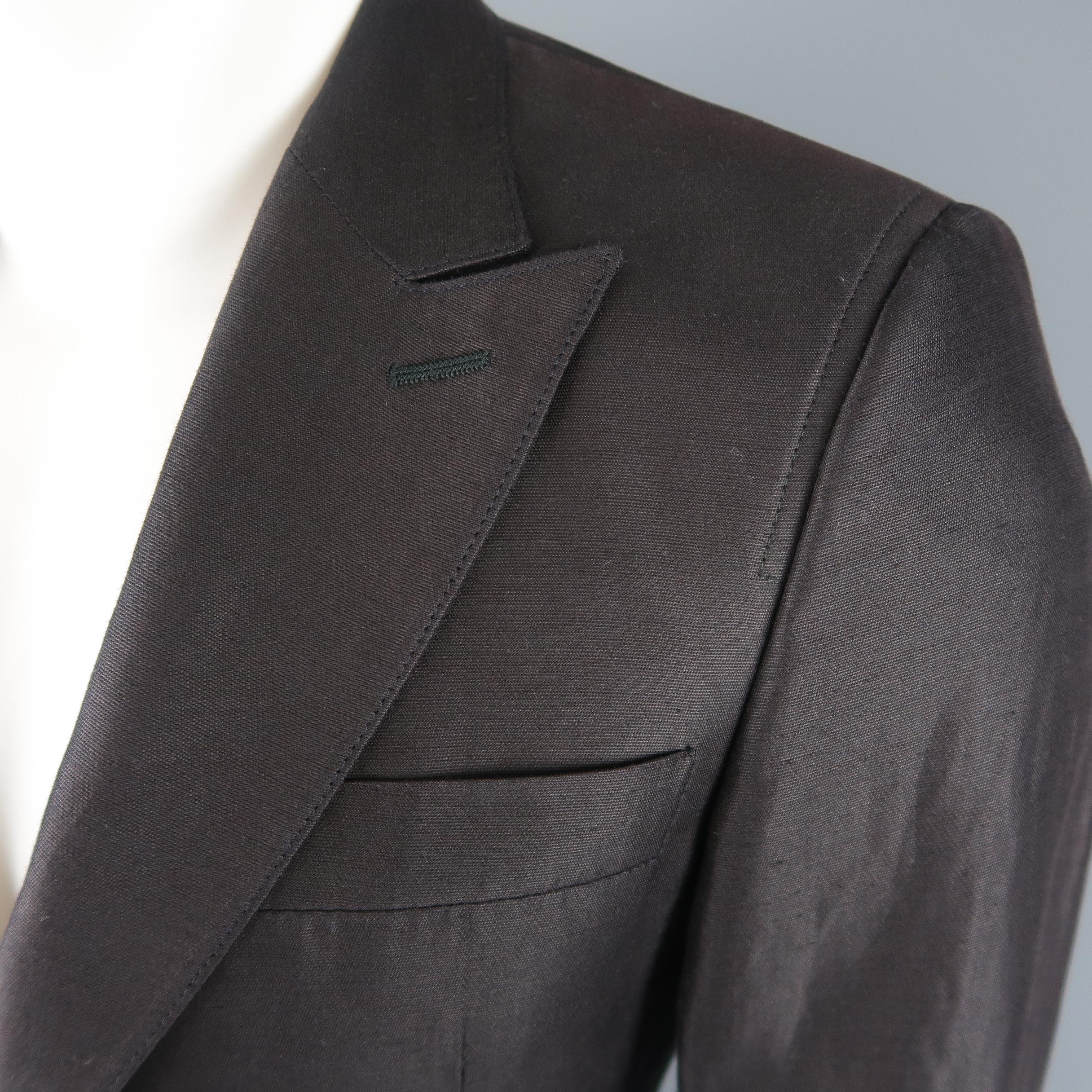 Single breasted COSTUME NATIONAL sport coat comes in a shiny cotton blend material with a peak lapel, top stitching, two button front, and hidden placket button cuff sleeves. Made in Italy.
 
Good Pre-Owned Condition.
Marked: (no size)
