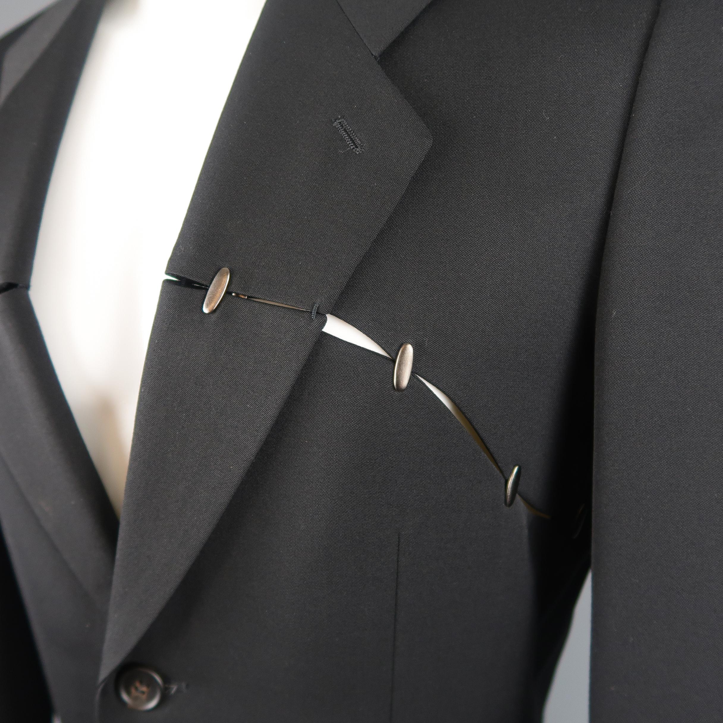 Vintage Single breasted Issey Miyake sport coat jacket comes in black wool with a notch lapel, two button front, and slit cutout panel adorned with silver tone studs. Made in Japan.
 
Good Pre-Owned Condition.
Marked: M
 
Measurements:
 
Shoulder: