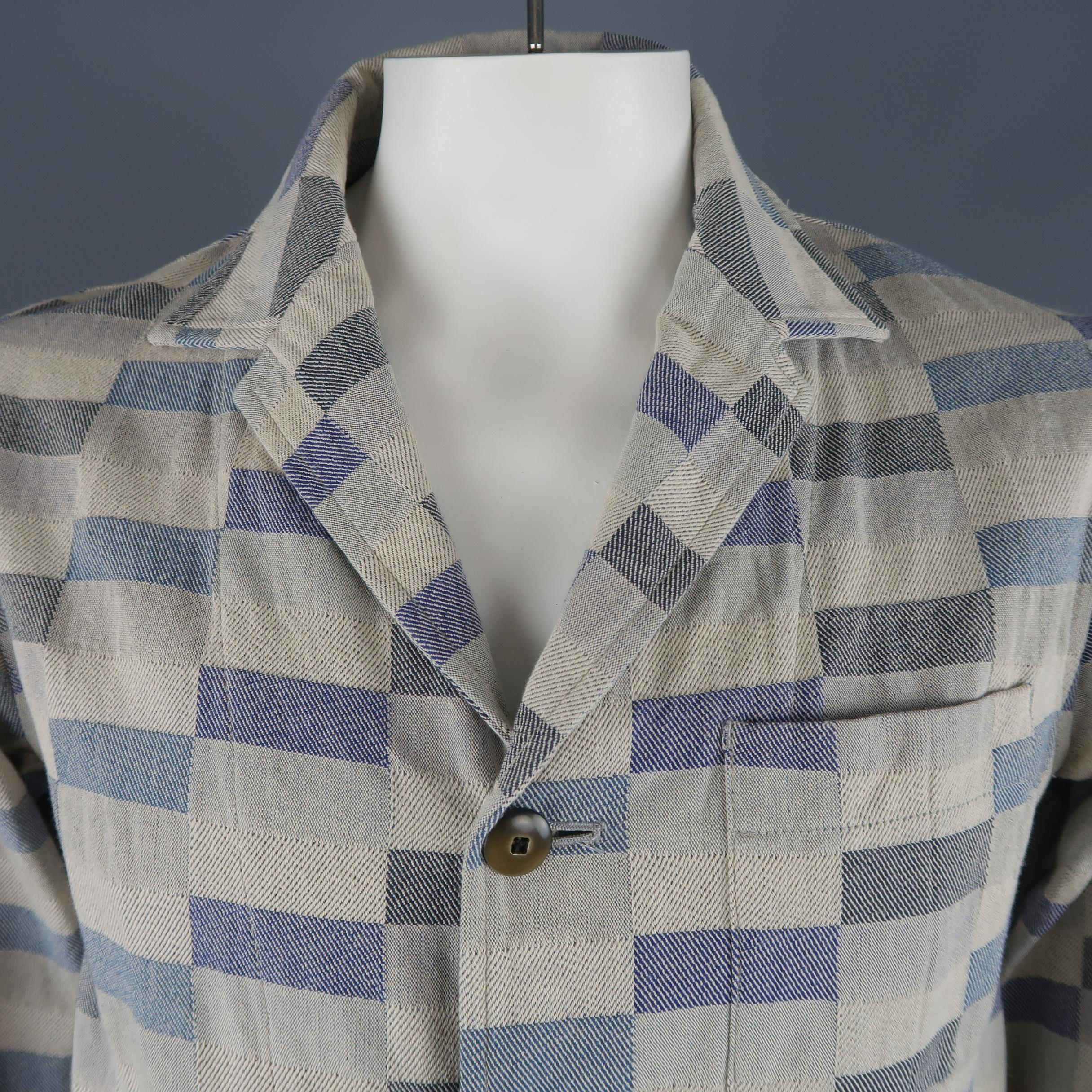 Single breasted TS(S) relaxed casual sport coat shirt jacket comes in beige and blue checkered print cotton twill with a notch lapel, three button front, functional button cuffs, and patch pockets. Made in Japan.
 
Good Pre-Owned Condition.
Marked: