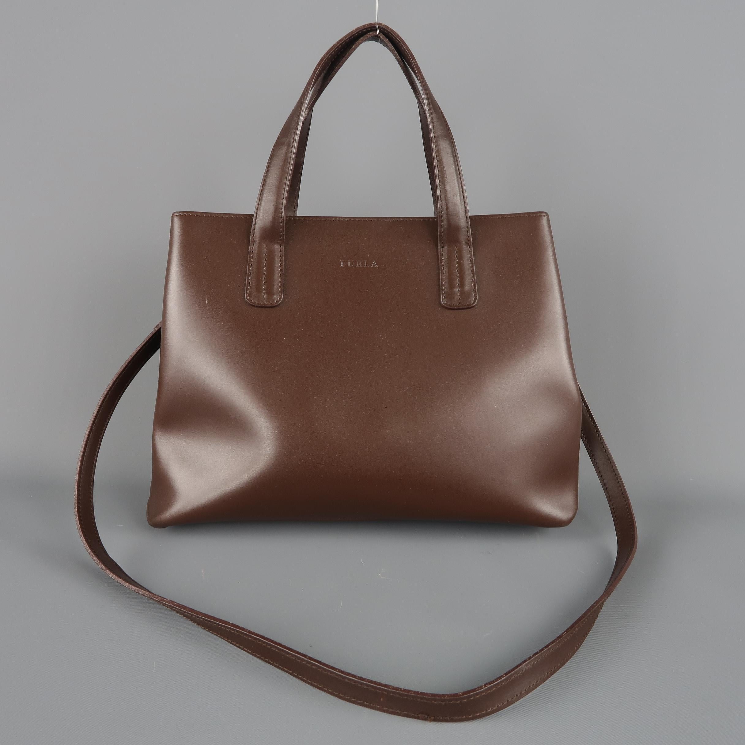 FURLA handbag comes in chocolate brown smooth leather with double top handles, folded sides, double compartments, and detachable shoulder strap. Wear throughout. Made in Italy.
 
Fair Pre-Owned Condition.
 
Measurements:
 
Length: 12 in.
Width: 4