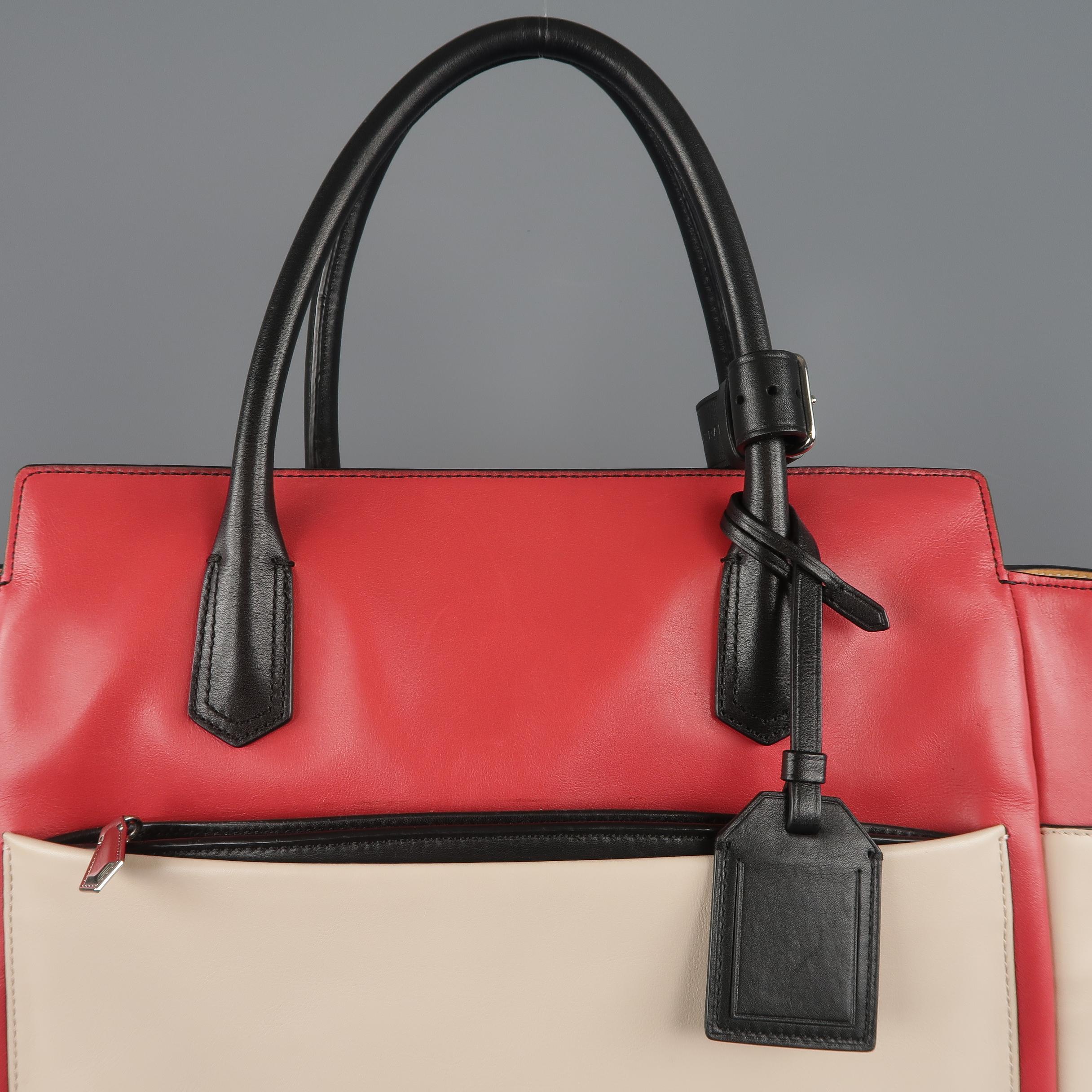 REED KRAKOFF tote bag comes in light pink leather with a light red top panel, black covered double top handles and piping, multi-pocket sides and back, and canvas interior. Some wear. Retails: $1490

Good Pre-Owned Condition.
 
Measurements:
Length: