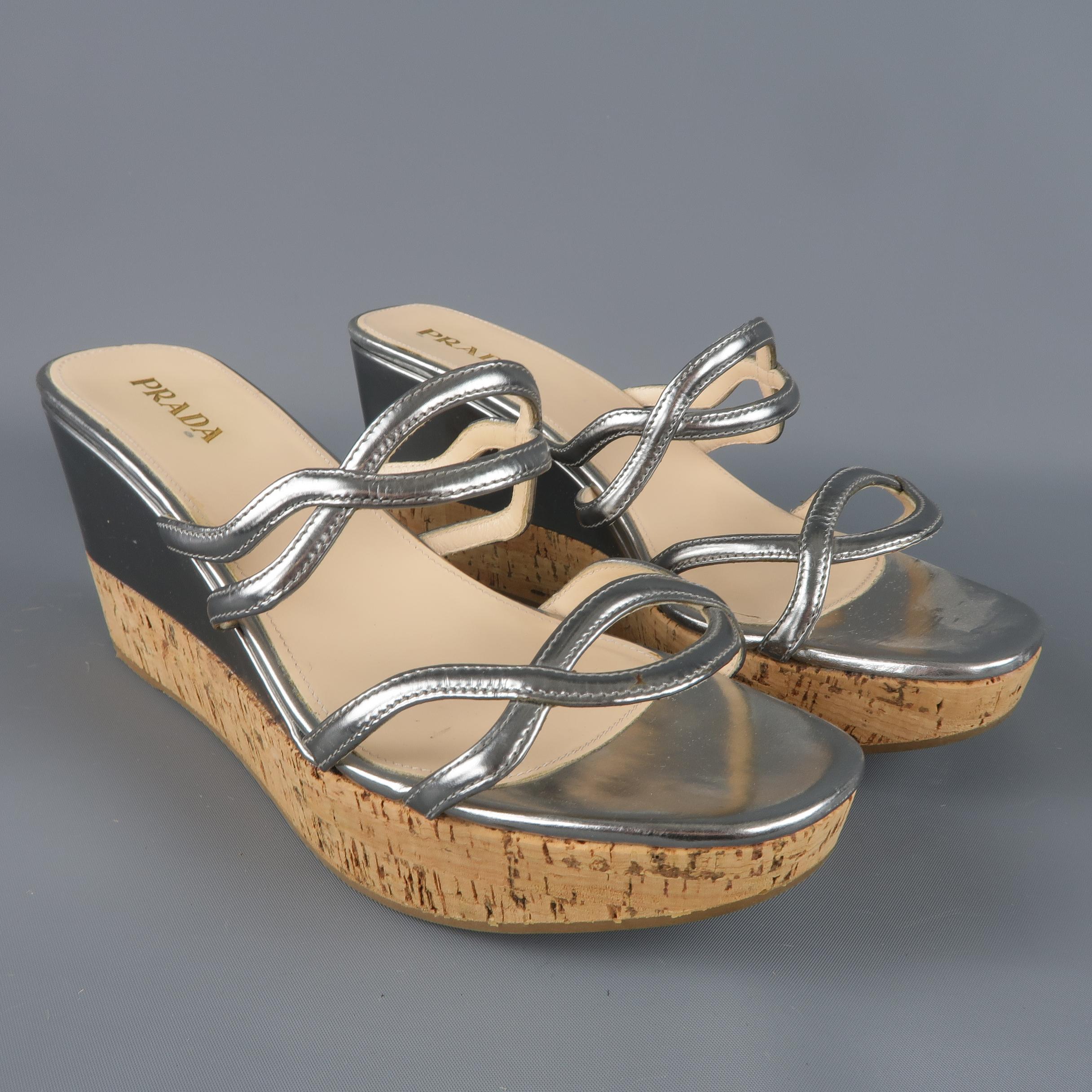 PRADA sandals come in metallic silver leather with double cutout straps and half covered platform cork wedge. Made in Italy.
 
Excellent Pre-Owned Condition.
Marked: IT 40
 
Measurements:
 
Heel: 3.5 in.
Platform: 1.25 in.