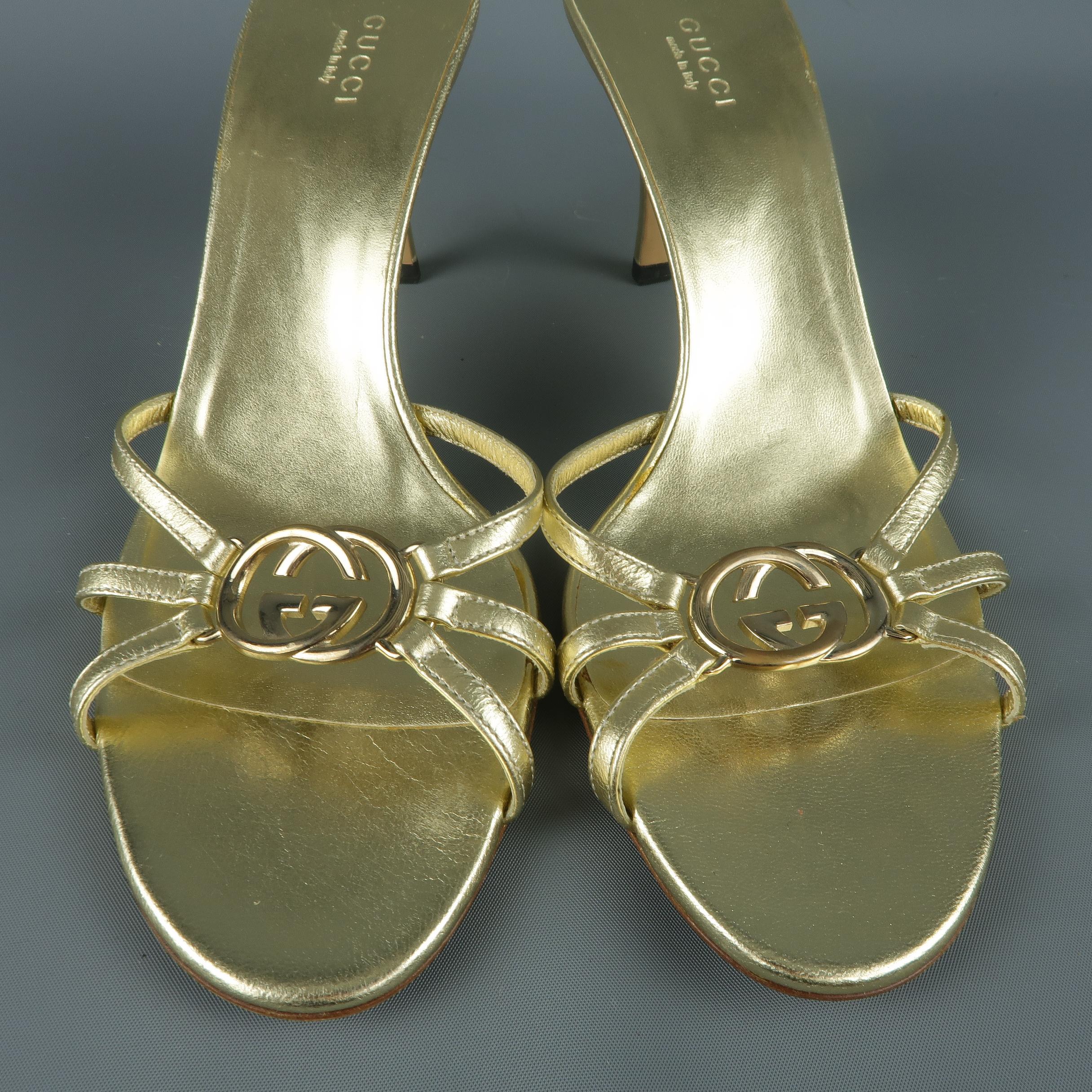 GUCCI mule sandals come in metallic gold leather with a covered stiletto heel and metal GG logo embellished toe strap.  Made in Italy.
 
Excellent Pre-Owned Condition.
Marked: IT 39
 
Measurements:
 
Heel: 3.5 in.