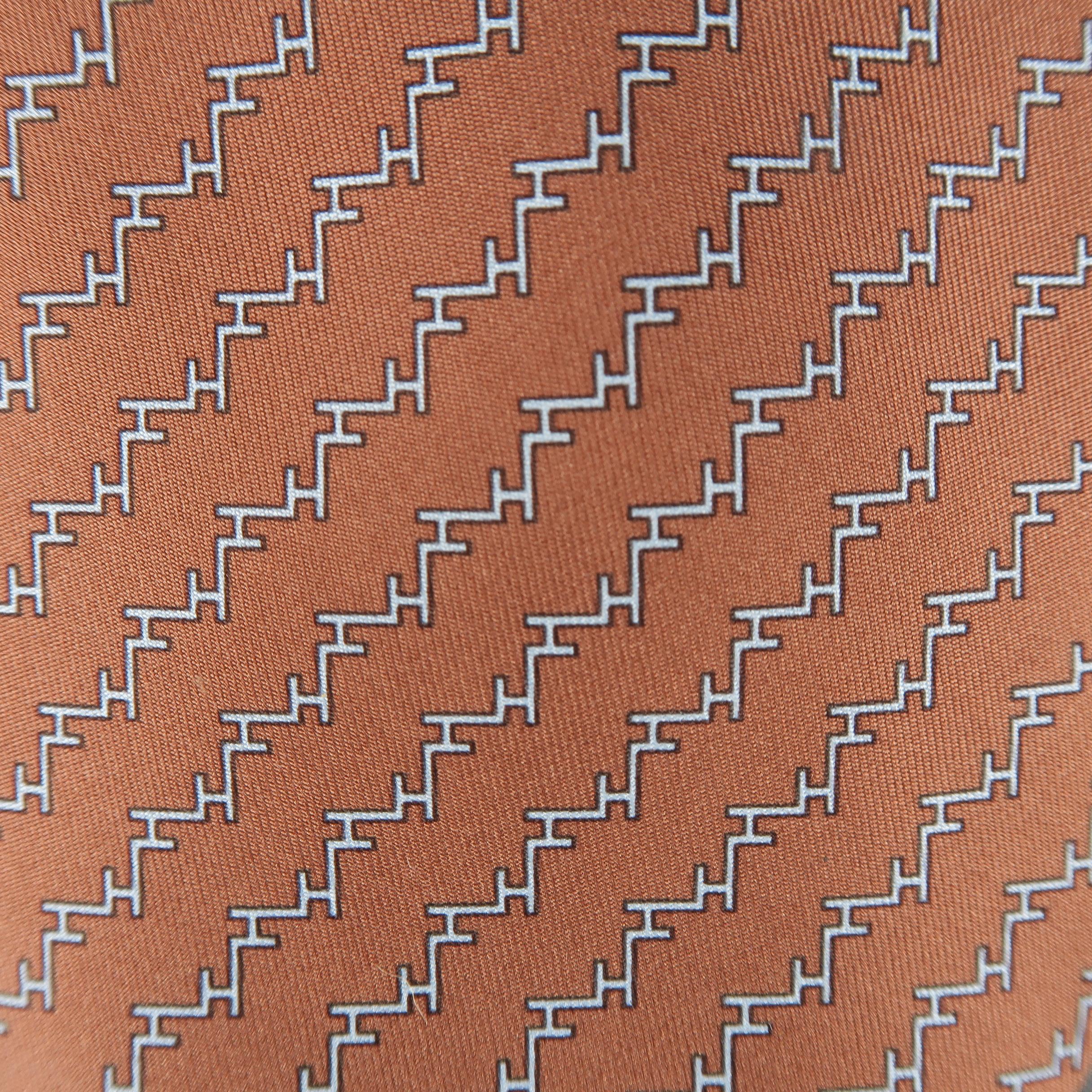 HERMES tie comes in brown silk twill with an all over gray interlocking H print. Made in France.
 
Excellent Pre-Owned Condition.
 
Width: 3.5 in.