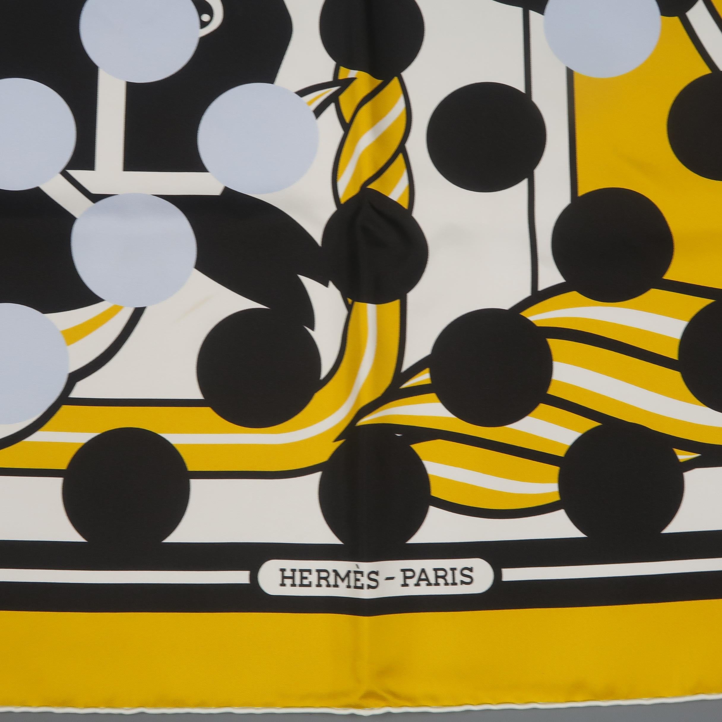This rare and collectable HERMES X COMME des GARCONS collaboration scarf comes in gold, black, and cream 