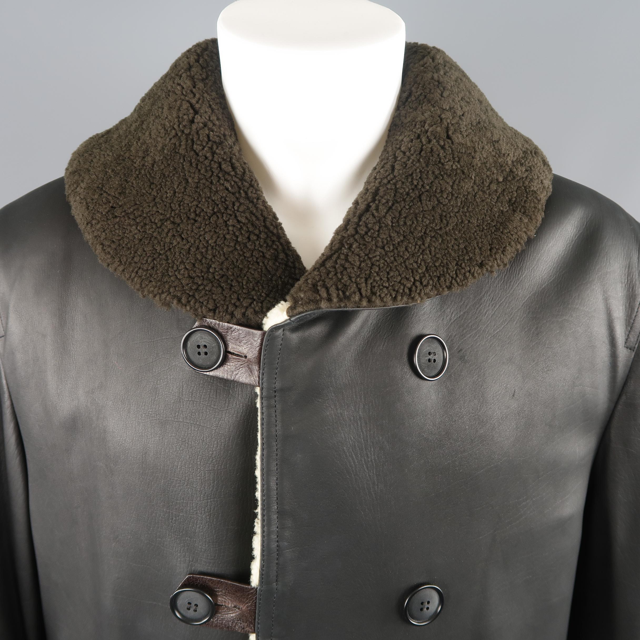 GIORGIO ARMANI coat comes in black leather with full cream shearling fur liner, olive shearling collar, and brown leather button tabs. Made in Italy.
 
Excellent Pre-Owned Condition.
Marked: IT 50
 
Measurements:
 
Shoulder: 19 in.
Chest: 46