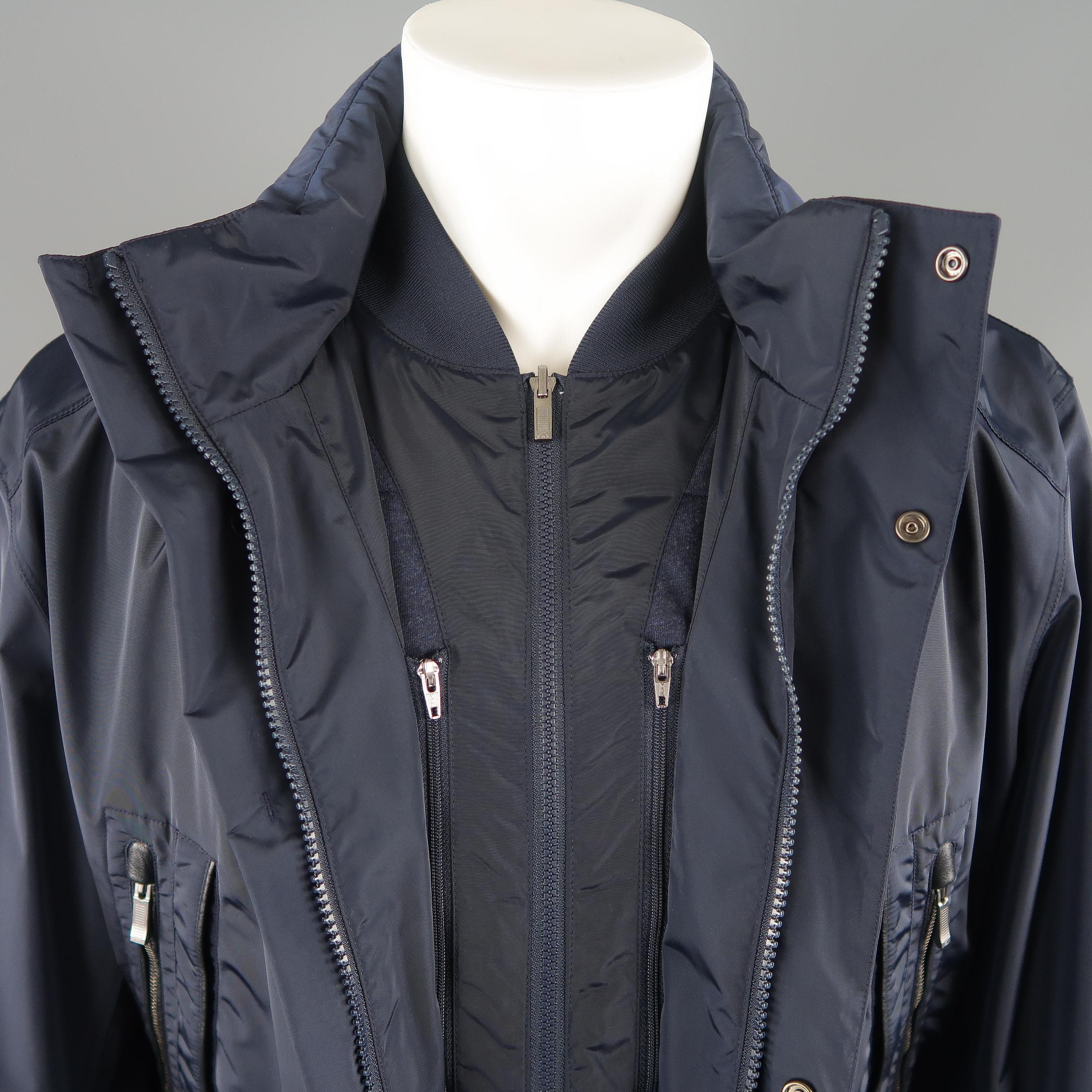 ZEGNA SPORT parka by ERMENEGILDO ZEGNA comes in navy polyamide blend with a drawstring waistband, zip front with snap placket, high collar with zip out hood, and internal zip vest layer.
 
Excellent Pre-Owned Condition.
Marked: XL
 
Measurements:
