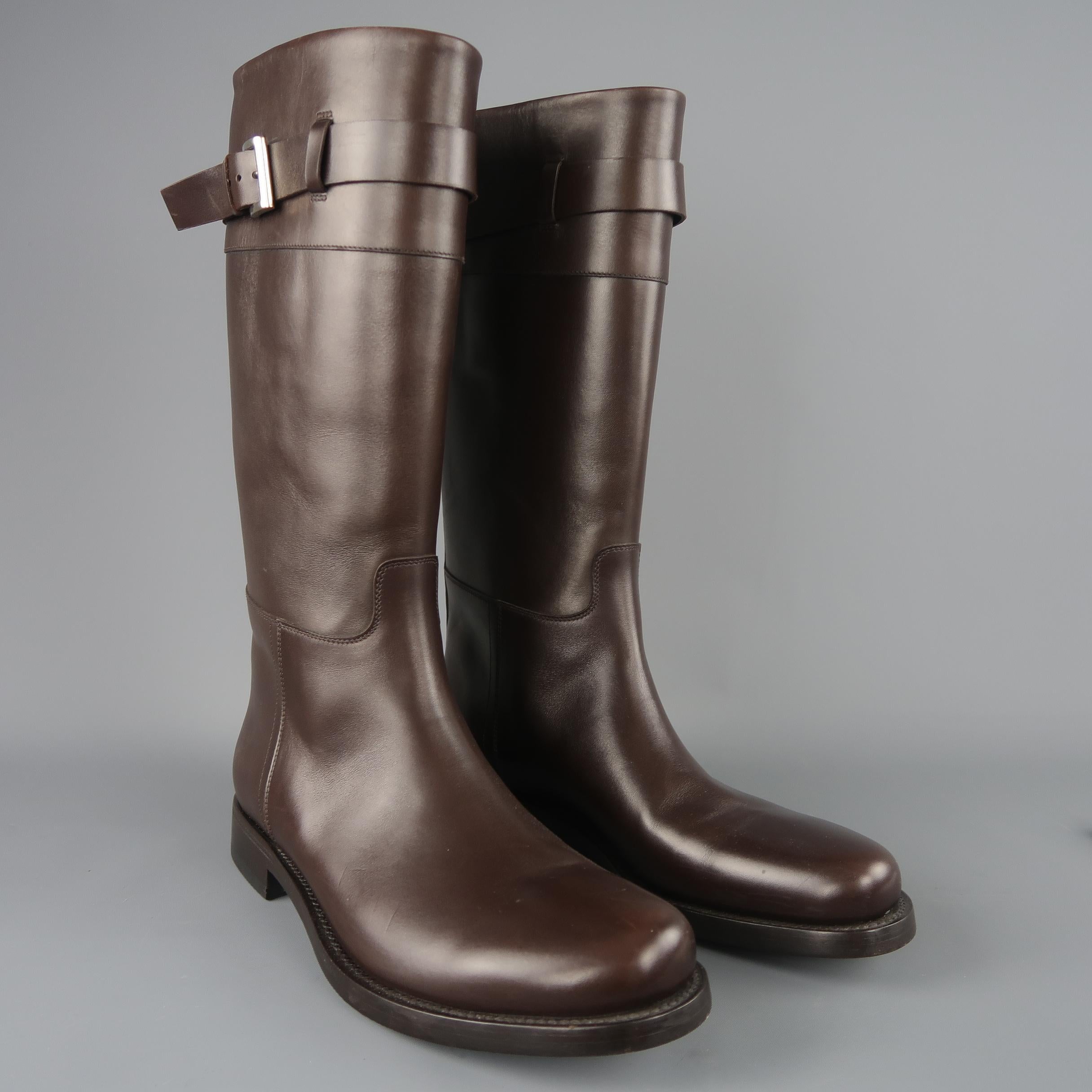 Prada biker style boots come in chocolate brown smooth leather with a tapered toe, heeled sole, and tall pull on shaft with silver tone buckled strap. Made in Italy.
 
New with Tag.
Marked: UK 10
 
Measurements:
Length: 15 in.