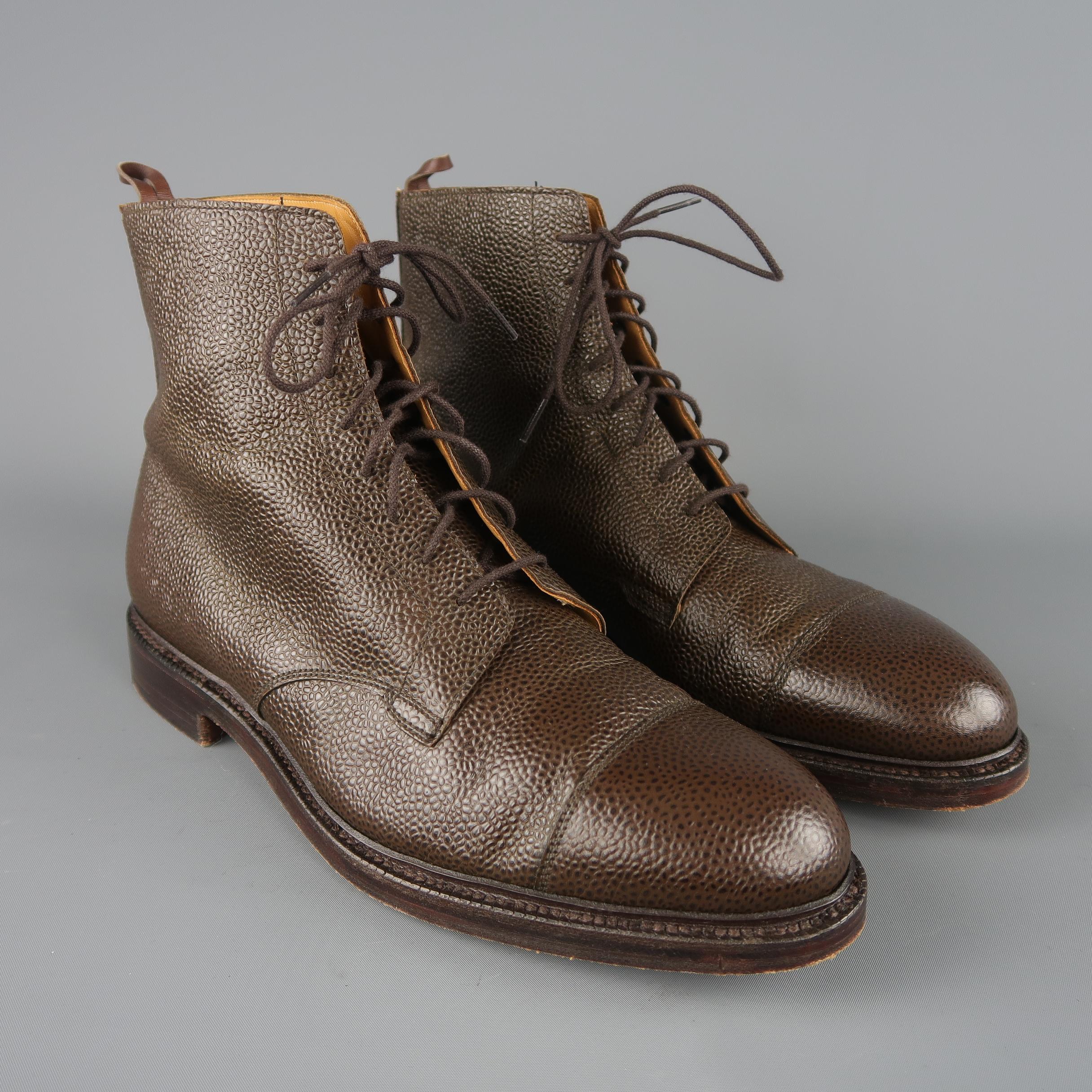 Black Fleece by Thom Browne ankle boots come in brown pebbled textured leather with a tapered cap toe, lace up front, and heeled stacked sole. Made in England.
 
Good Pre-Owned Condition.
Marked: UK 10.5 D
 
Measurements:
 
Length: 6 in.