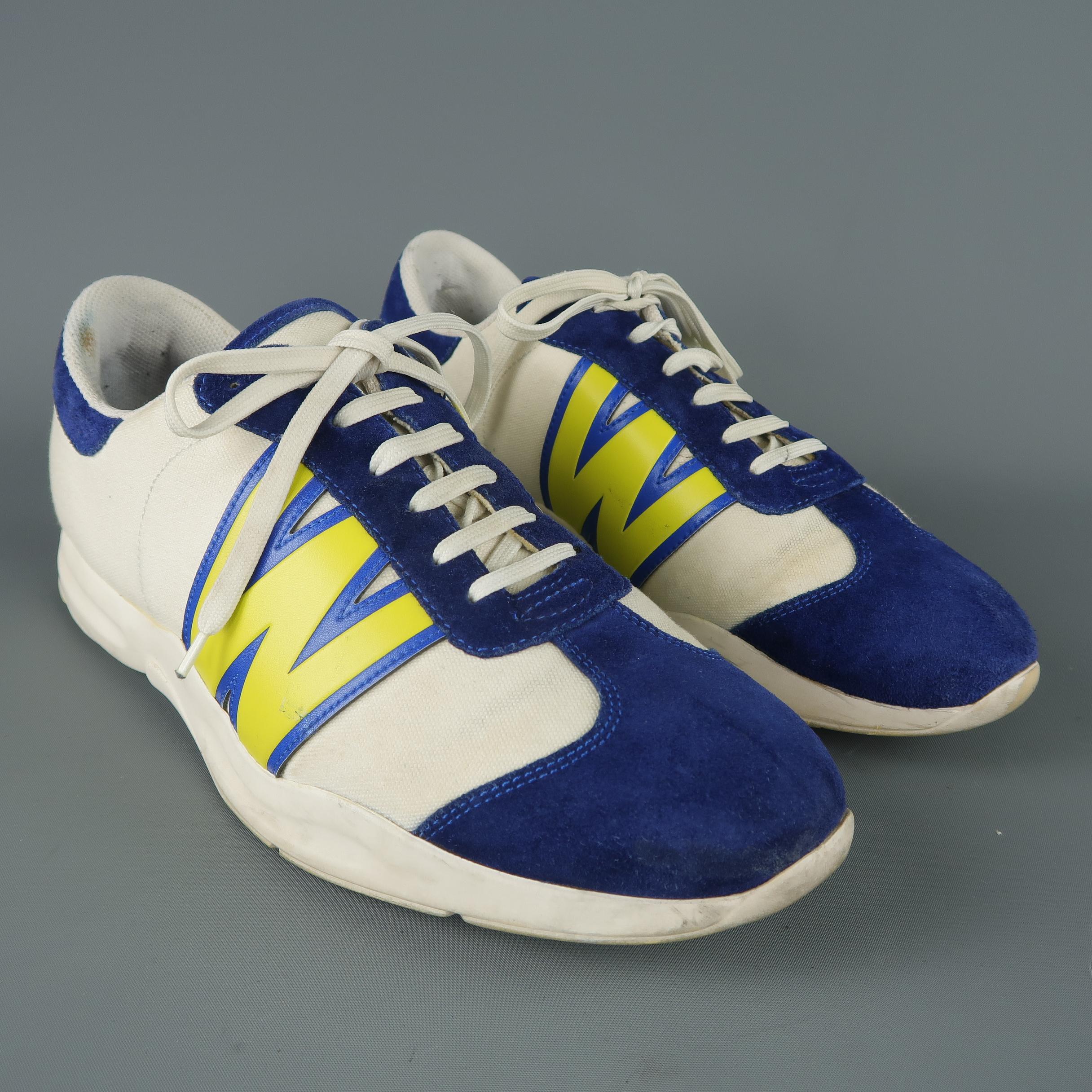 VINTAGE W<  WALTER VAN BEIRENDONCK sneakers come in cream canvas with blue suede panels, thick rubber sole, and yellow leather W decals. Wear throughout. As-is.
 
Vintage Pre-Owned Condition.
Marked: USA 9
