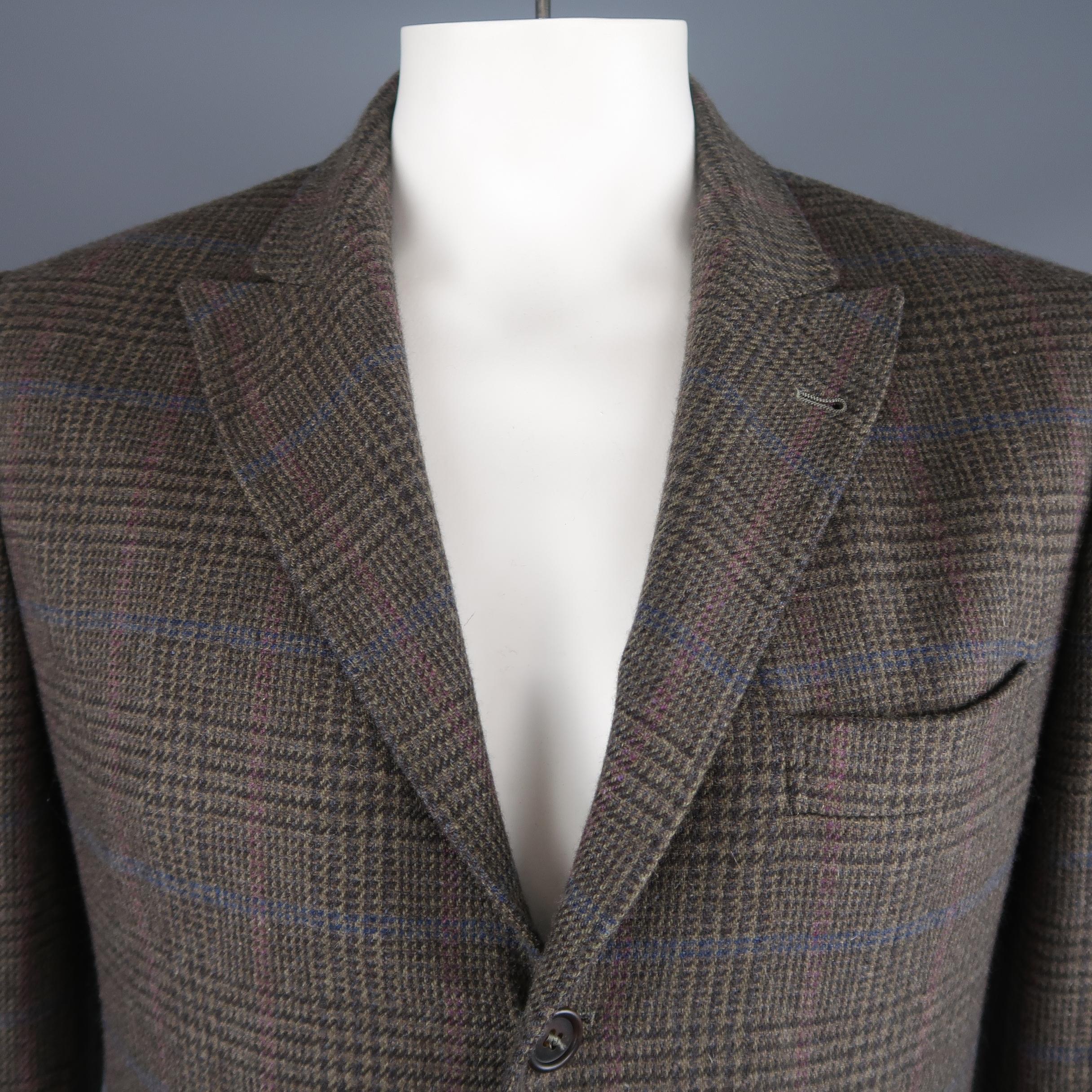 Single breasted Brunello Cucinelli sport jacket comes in taupe glenplaid cashmere with purple and blue stripes throughout, three button front, peak lapel, and double vented back. Made in Italy.
 
Excellent Pre-Owned Condition.
Marked: IT 52

