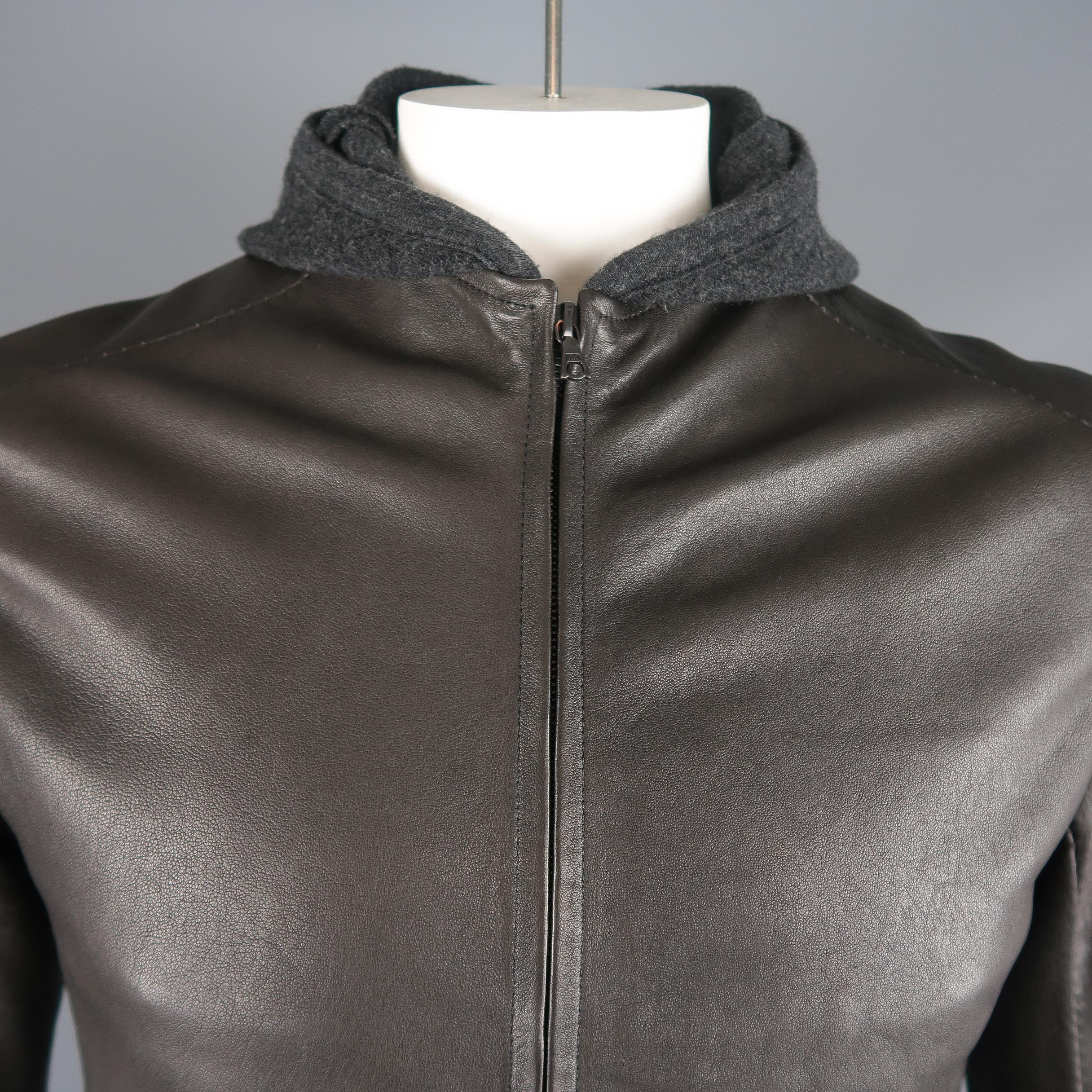 Isaac Sellam jacket comes in dark gray lambskin leather with a zip up front, slit pockets, and extended wool knit liner and hood. Made in France.
 
Excellent Pre-Owned Condition.
Marked: L
 
Measurements:
 
Shoulder: 19 in.
Chest: 44 in.
Sleeve:  27