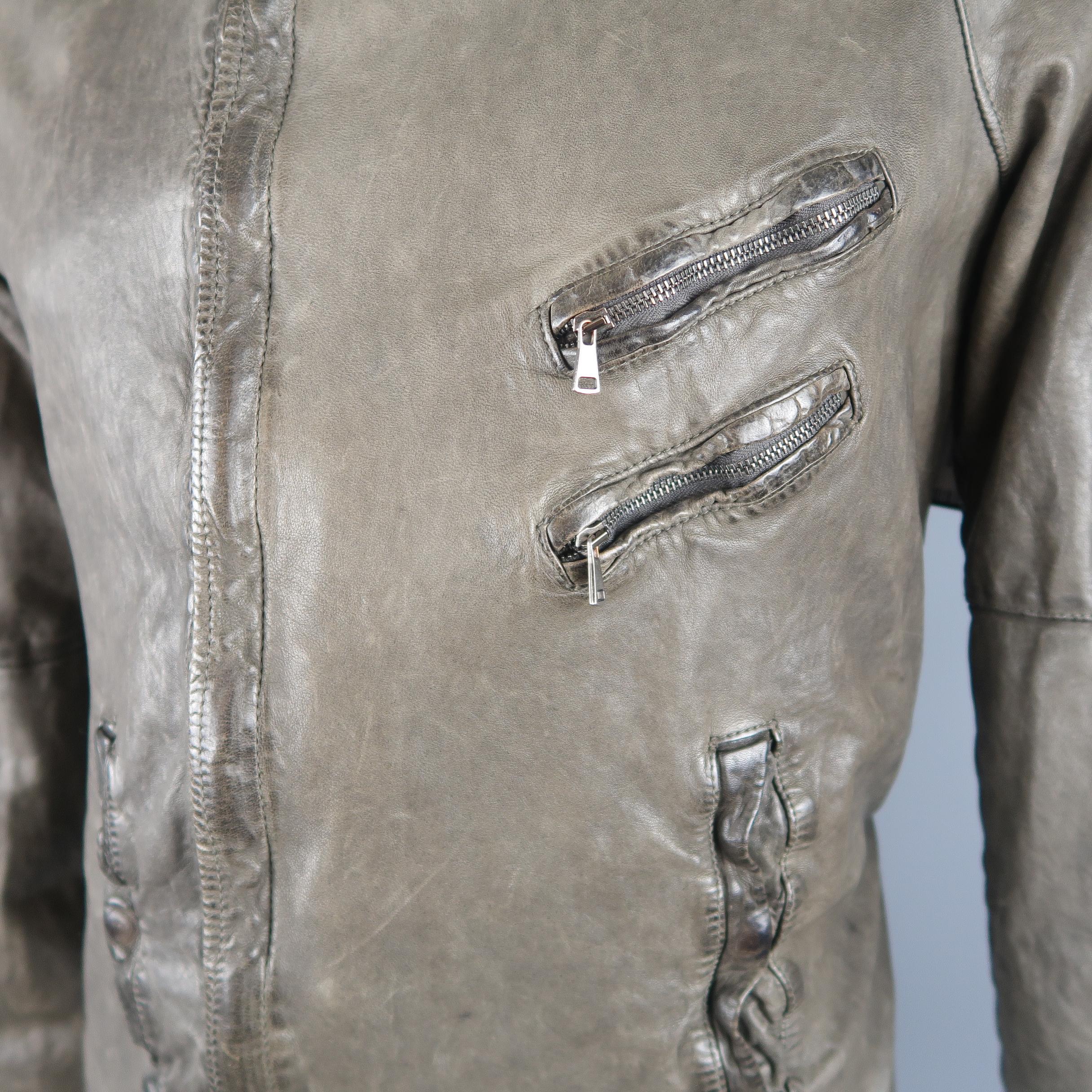 Giorgio Brato biker jacket comes in distressed dyed leather with a high collar, hidden placket double zip front, zip pockets, snap cuffs, back belt, and knit liner. Made in Italy.
 
Good Pre-Owned Condition.
Marked: IT 54
 
Measurements:
 
Shoulder: