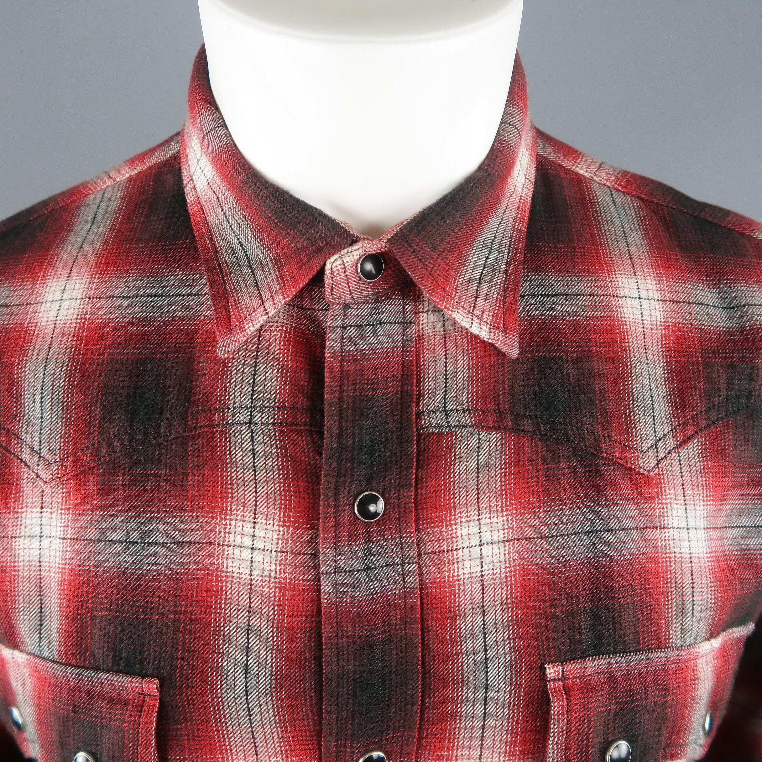 Saint Laurent Western style shirt comes in black and red plaid cotton with patch flap pockets and black pearl snaps. Made in Japan.
 
Excellent Pre-Owned Condition.
Marked:L
 
Measurements:
 
Shoulder: 17.5 in.
Chest: 45 in.
Sleeve: 23 in.
Length: