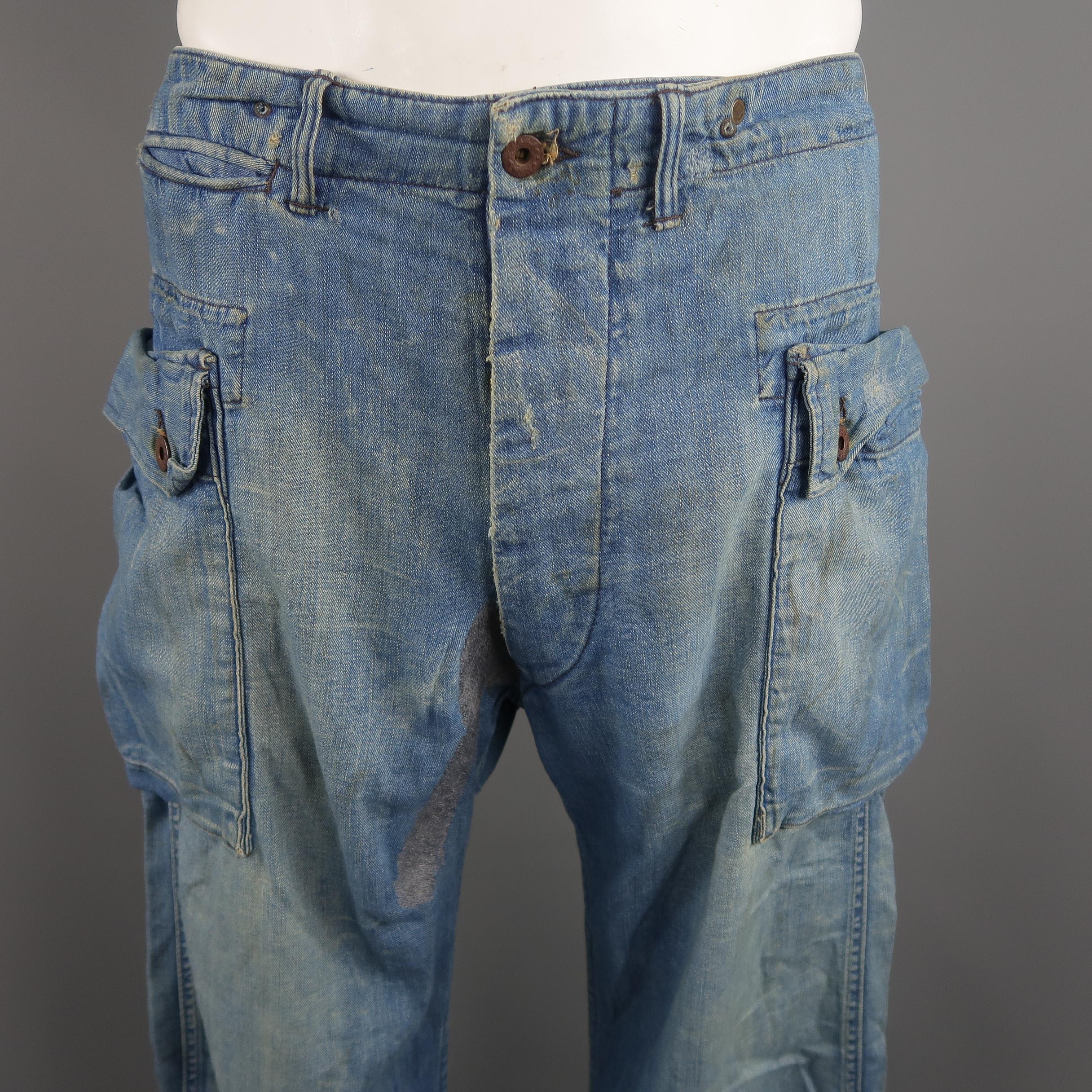 RRL by Ralph Lauren pants come in washed and distressed medium wash denim with a button fly, oversized cargo pockets, and reconstructed stitch embroidery details. Made in USA.
 
Good Pre-Owned Condition.
Marked: 33 x 32
 
Measurements:
 
Waist: 36