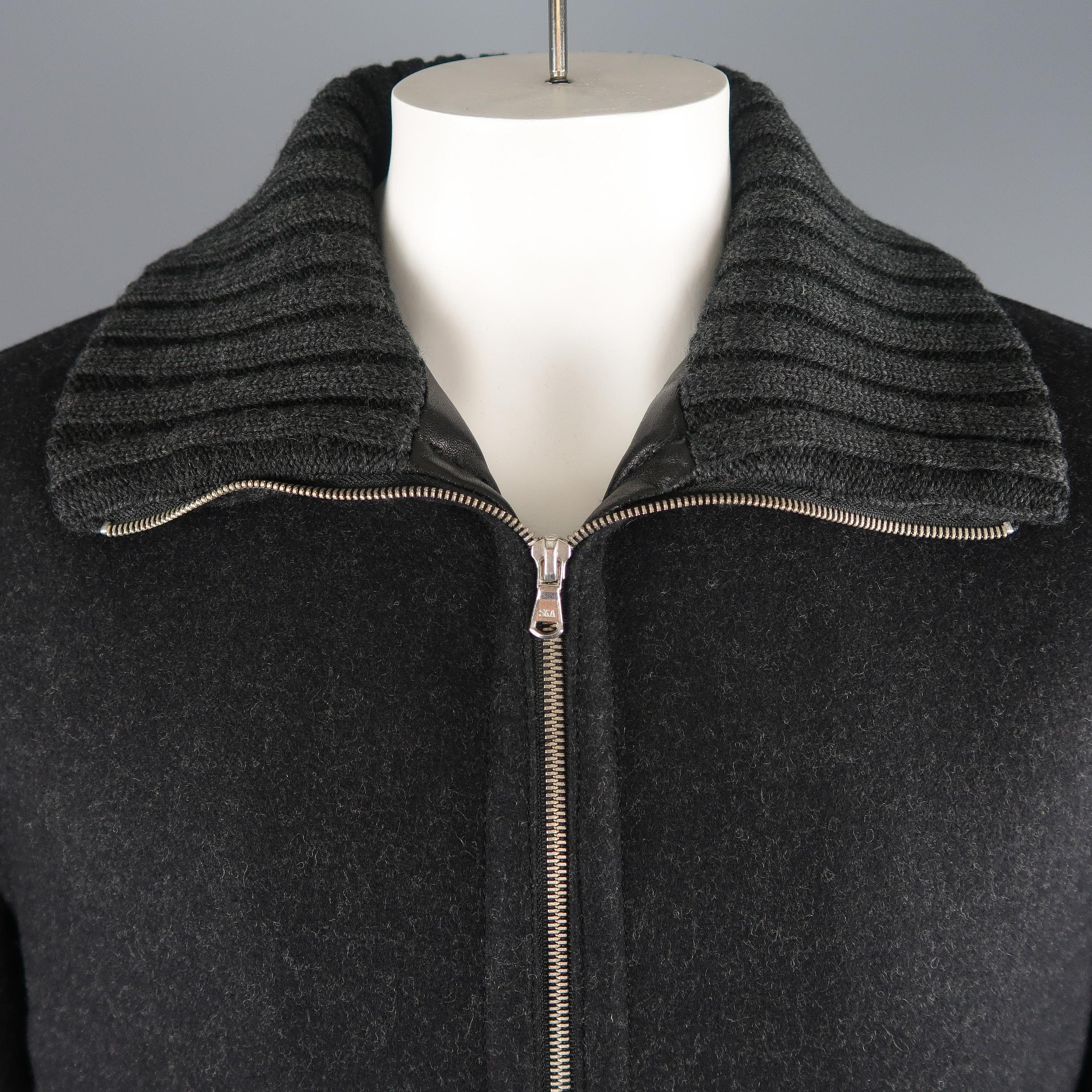 Dolce & Gabbana jacket comes in charcoal gray textured wool with a zip up front, leather detailed slated pockets, quilted liner, and cable knit collar. Made in Italy.
 
Excellent Pre-Owned Condition.
Marked: IT 52
 
Measurements:
 
Shoulder: 18