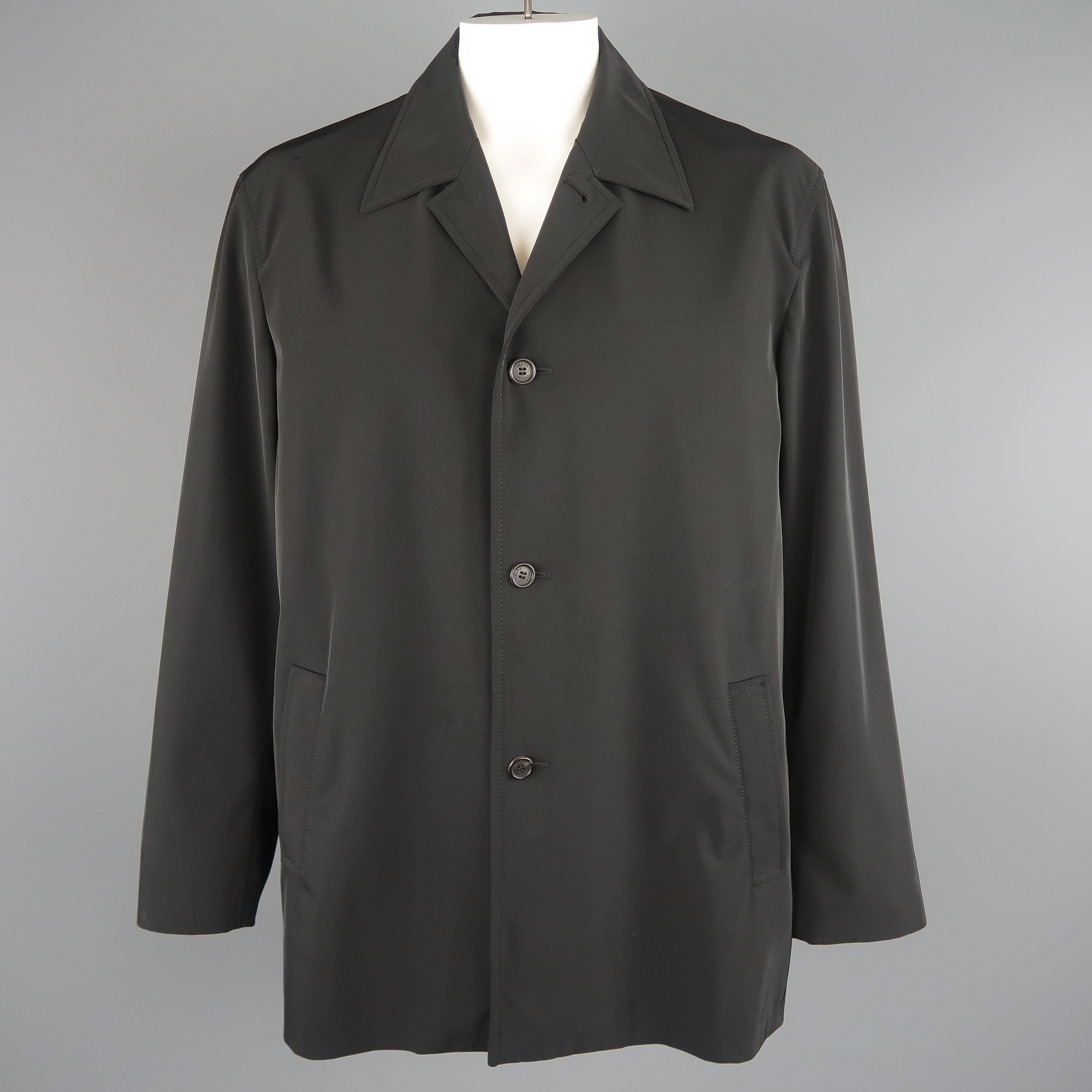 Prada overcoat comes in black polyester blend twill with a pointed collar, button up front, slanted pockets, and button cuffs. Wear throughout. As-is. Made in Italy.
 
Fair Pre-Owned Condition.
Marked: XXL
 
Measurements:
 
Shoulder: 20 in.
Chest: