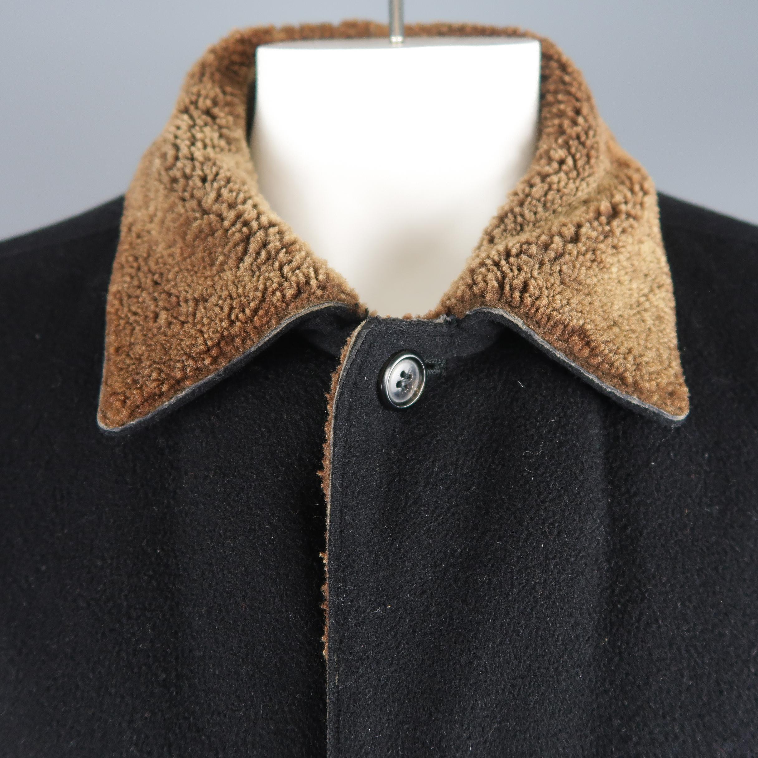 Barney's New York car coat comes in black wool with  button up front, slanted pockets and brown faux shearling collar and liner. Wear on shearling. As-is. Made in Italy.
 
Good Pre-Owned Condition.
Marked: IT 52
 
Measurements:
 
Shoulder: 19