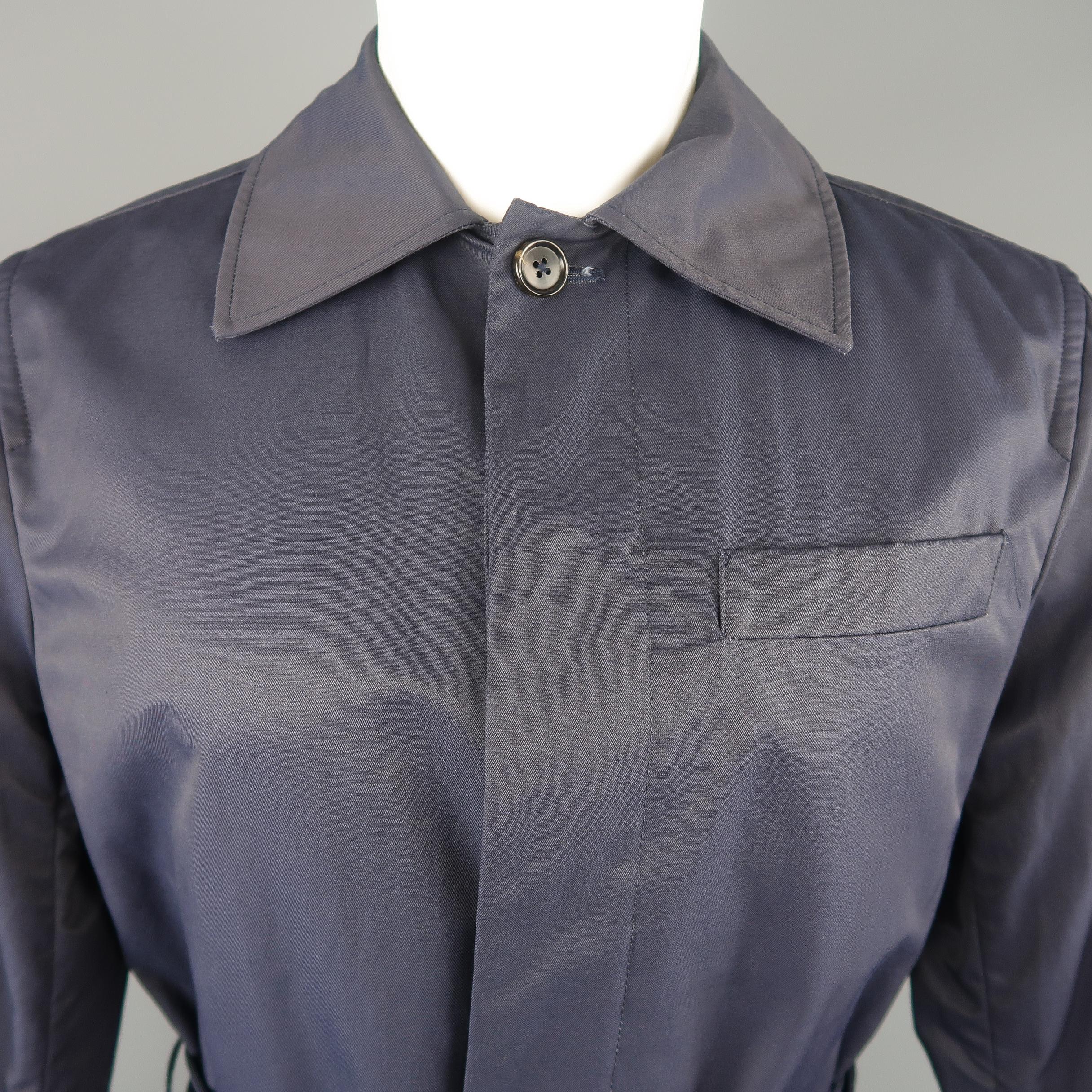 Men's J. Press car coat comes in navy twill with a pointed collar, belted cuffs, patch pockets, and belted waist. Made in USA.
 
New with Tags.
Marked: S
 
Measurements:
 
Shoulder: 17 in.
Chest: 44 in.
Sleeve: 26 in.
Length: 37 in.