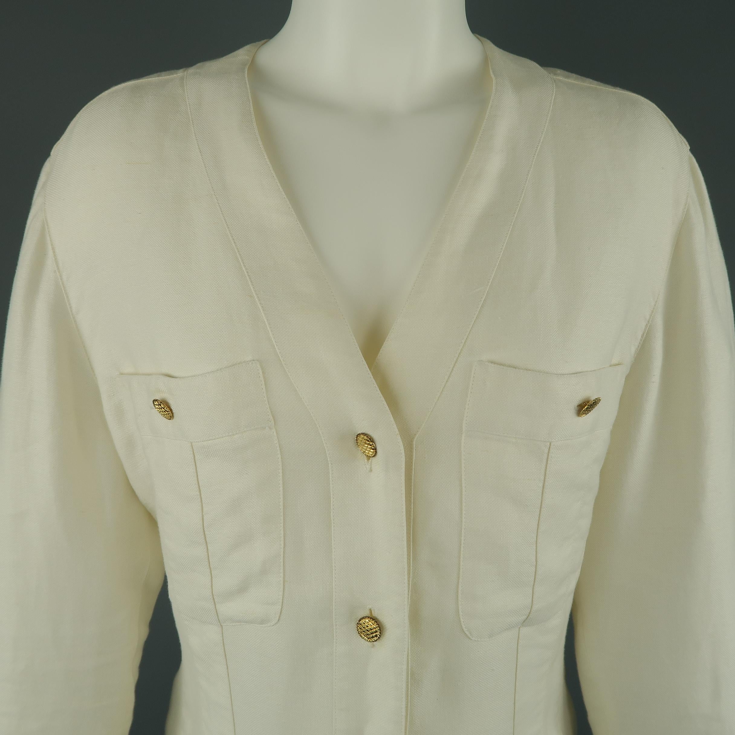 Vintage Chanel summer jacket comes in cream linen with a V neckline, yellow gold tone metal buttons, and patch button pockets. Discolorations throughout. Circa 1980's. As-is. Made in France.
 
Good Pre-Owned Condition.
Marked: FR 36
 
Measurements:
