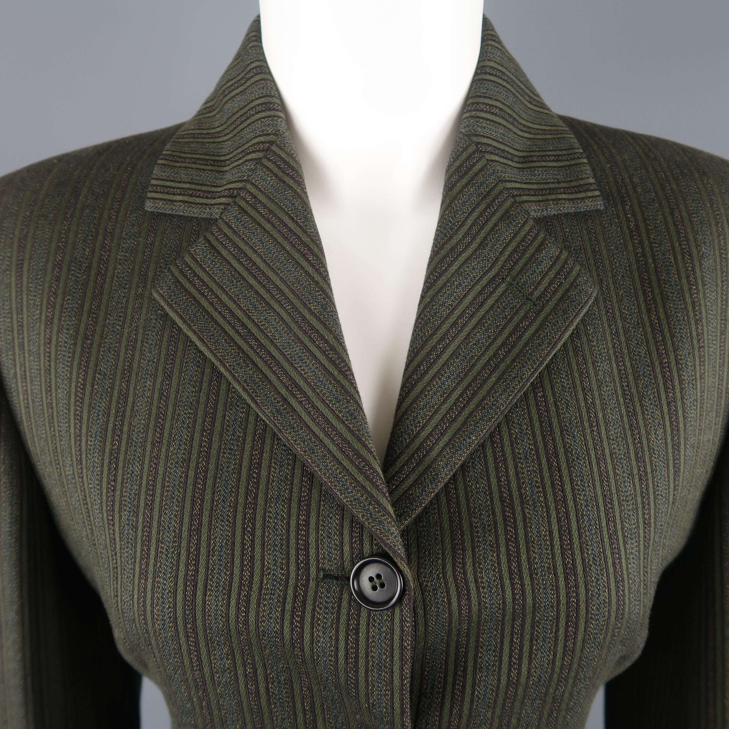 Vintage Romeo Gigli sport jacket comes in green and brown pinstripe pattern cotton with a pointed lapel,single breasted three button half closure, and cascading ruffle hem with long back slit. Made in Italy.
 
Excellent Pre-Owned Condition.
Marked: