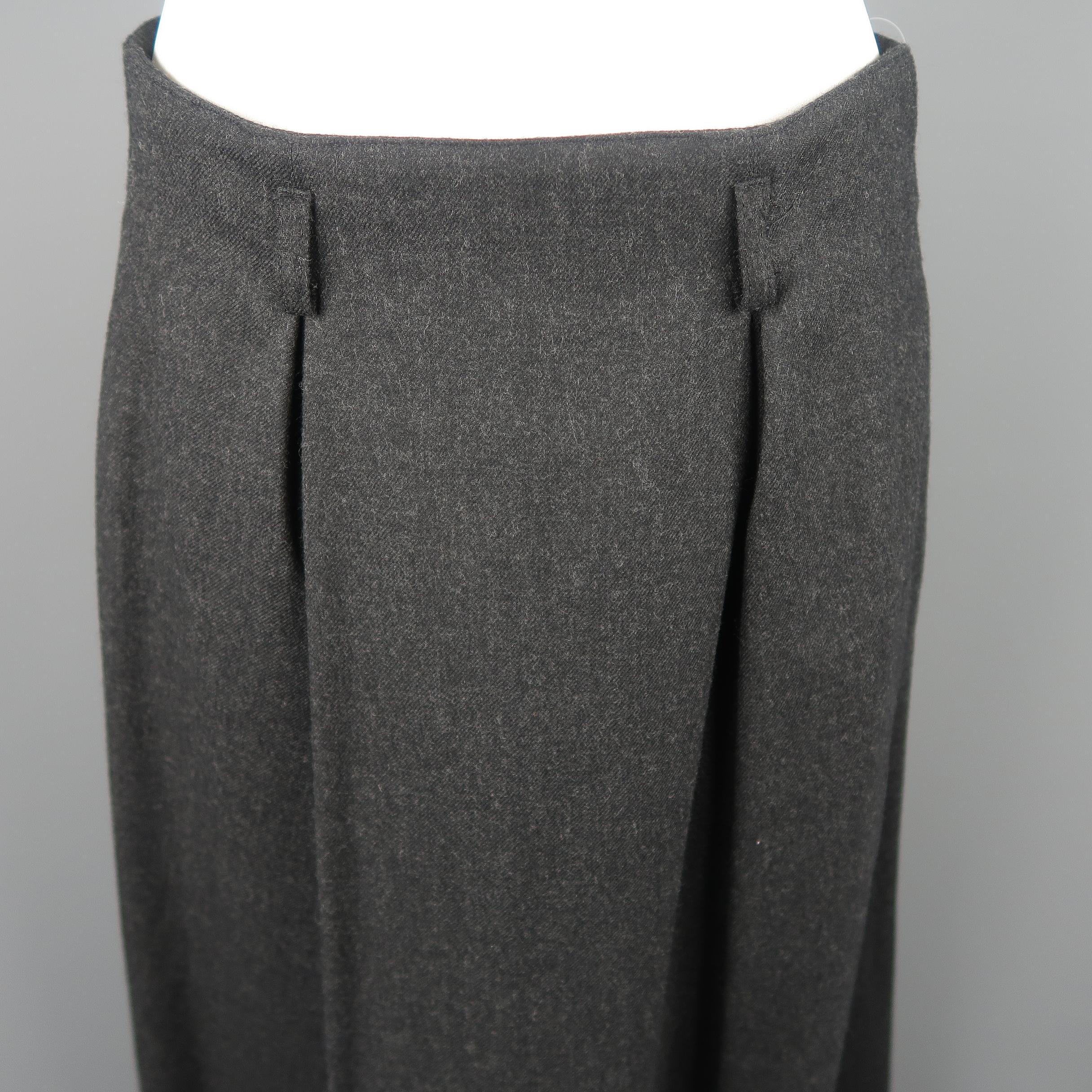 Christian Dior A-line midi skirt, come in wool in charcoal tone, with frontal pleats, pockets and zipper on the back. Made in USA.
 
Excellent Pre-Owned Condition.
Marked: US 8
 
Measurements:
 
Waist: 29 in.
Hip: 44 in.
Length: 33.5 in.