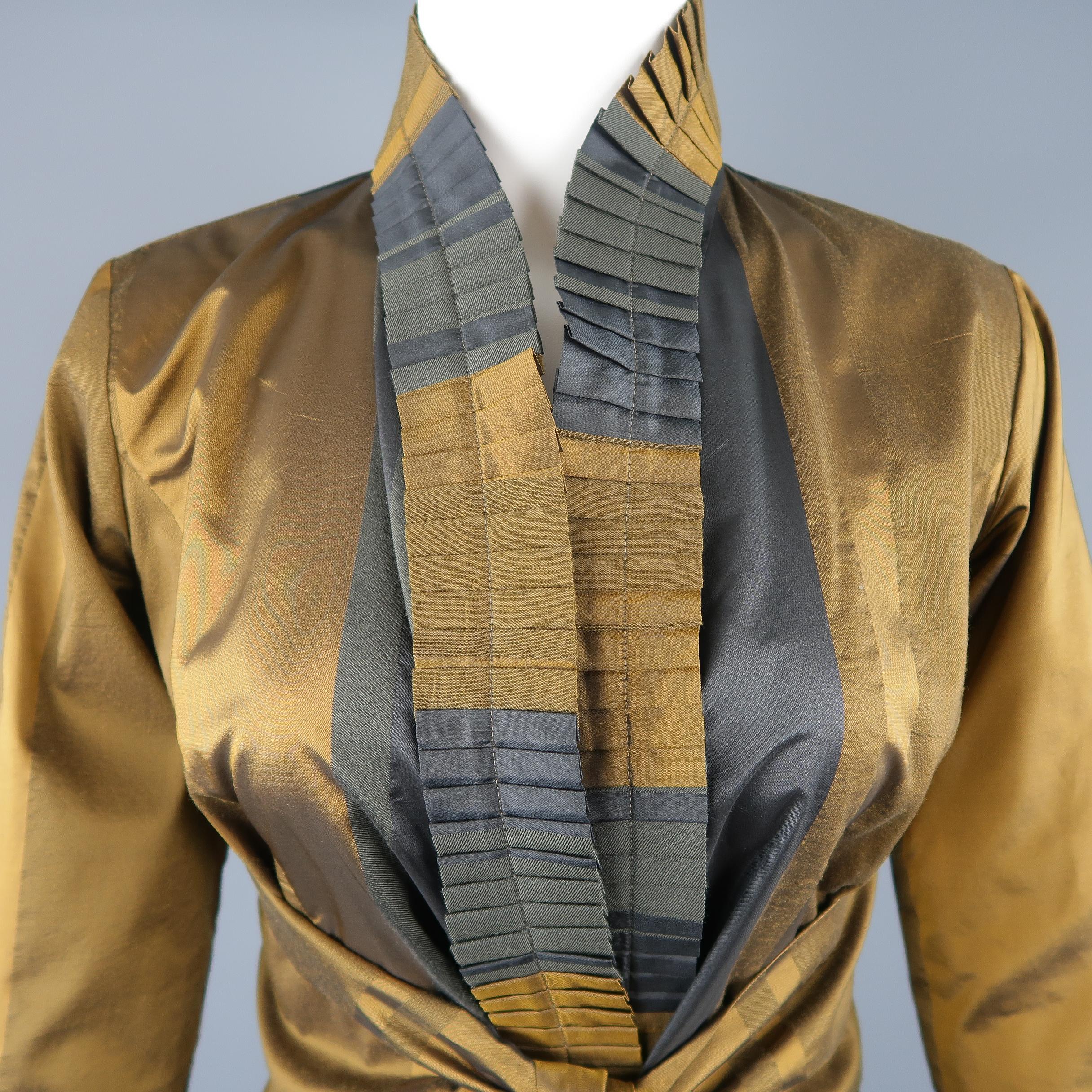 Etro jacket comes in a striped dark gold and teal taffeta/twill material with a pleated ruffle shawl collar and tied belt waist. Made in Italy.
 
Excellent Pre-Owned Condition.
Marked: IT 42
 
Measurements:
 
Shoulder: 15 in.
Bust: 34 in.
Sleeve: 24
