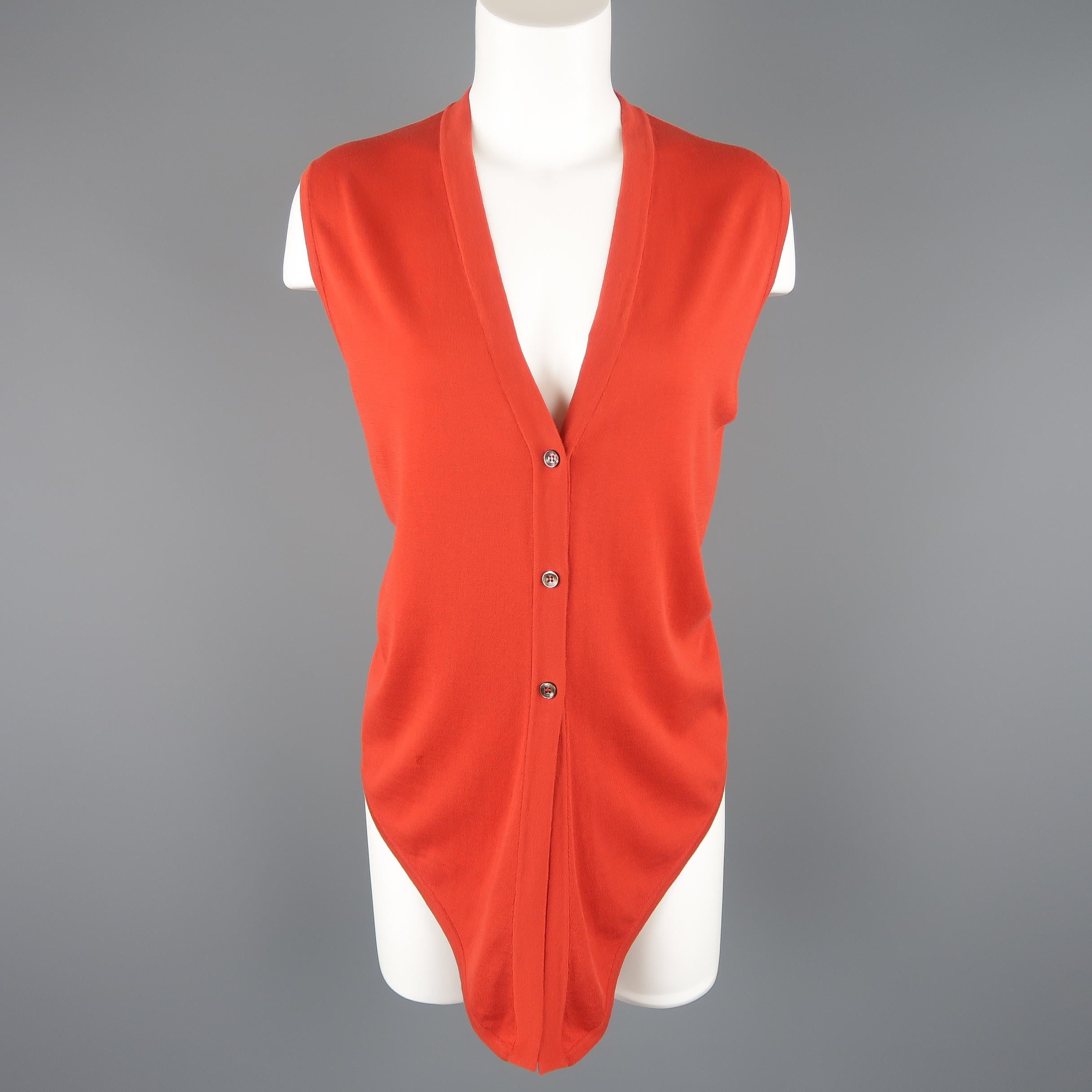 Vintage HERMES vest comes in burnt orange fine cotton knit with a v-neck, button up front, and pointed tie hem. Made in Italy.
 
Good Pre-Owned Condition.
Marked: LA
 
Measurements:
 
Shoulder: 15.5 in.
Bust: 38 in.
Length: 25-30 in.