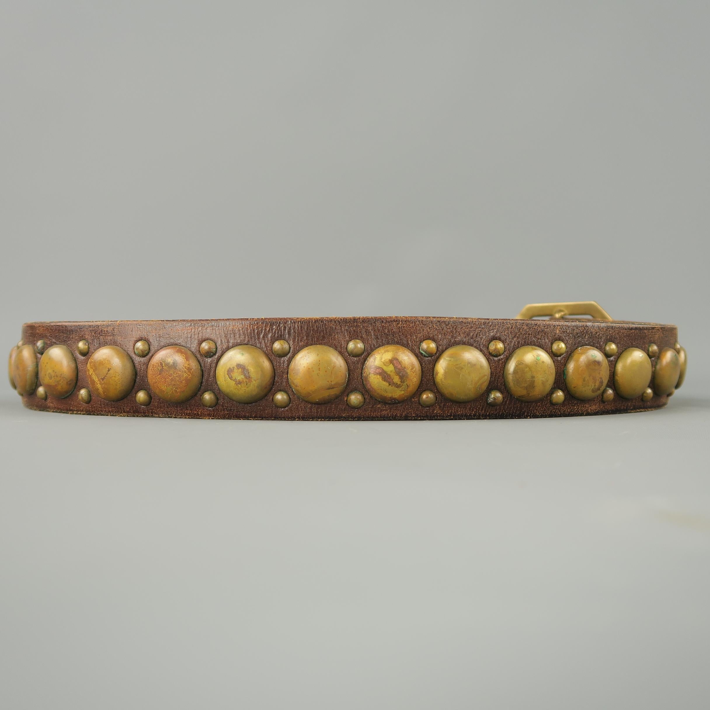 RRL by RALPH LAUREN belt features a brown distressed leather strap with antique gold tone dome studs and a hexagonal buckle. Missing stud. Made in Italy.
 
Good Pre-Owned Condition.
Marked: 38
 
Length: 46.5 in.
Width: 36.5-40.5 in.
Fits: 1.5 in.