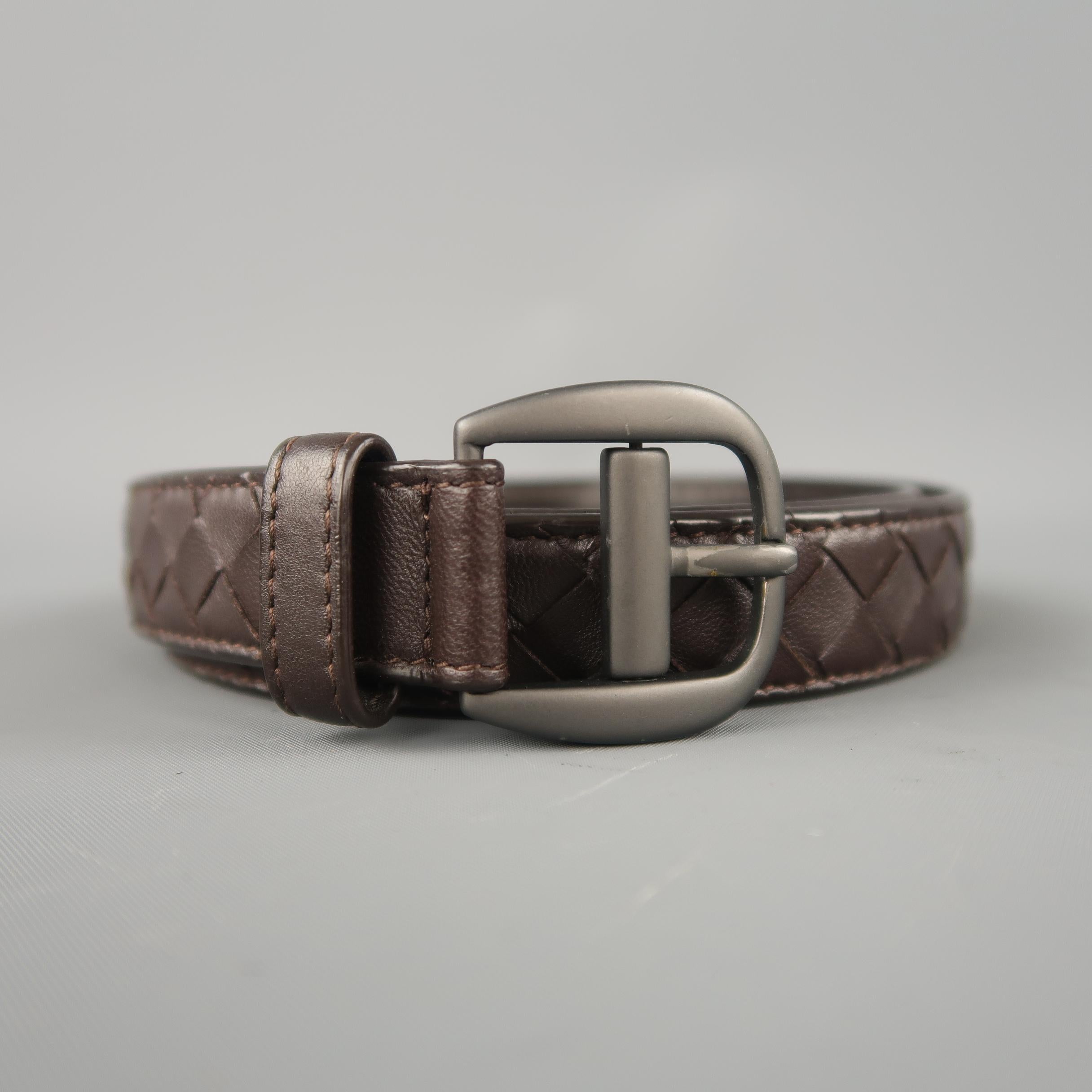 BOTTEGA VENETA skinny belt features a chocolate brown woven Intrecciato leather strap with a dark silver tone buckle. Made in Italy.
 
Excellent Pre-Owned Condition.
Marked: 85 cm 34 in
 
Length: 39.5 in.
Width: 0.95 in.
Fits: 30.5-35.5 in.