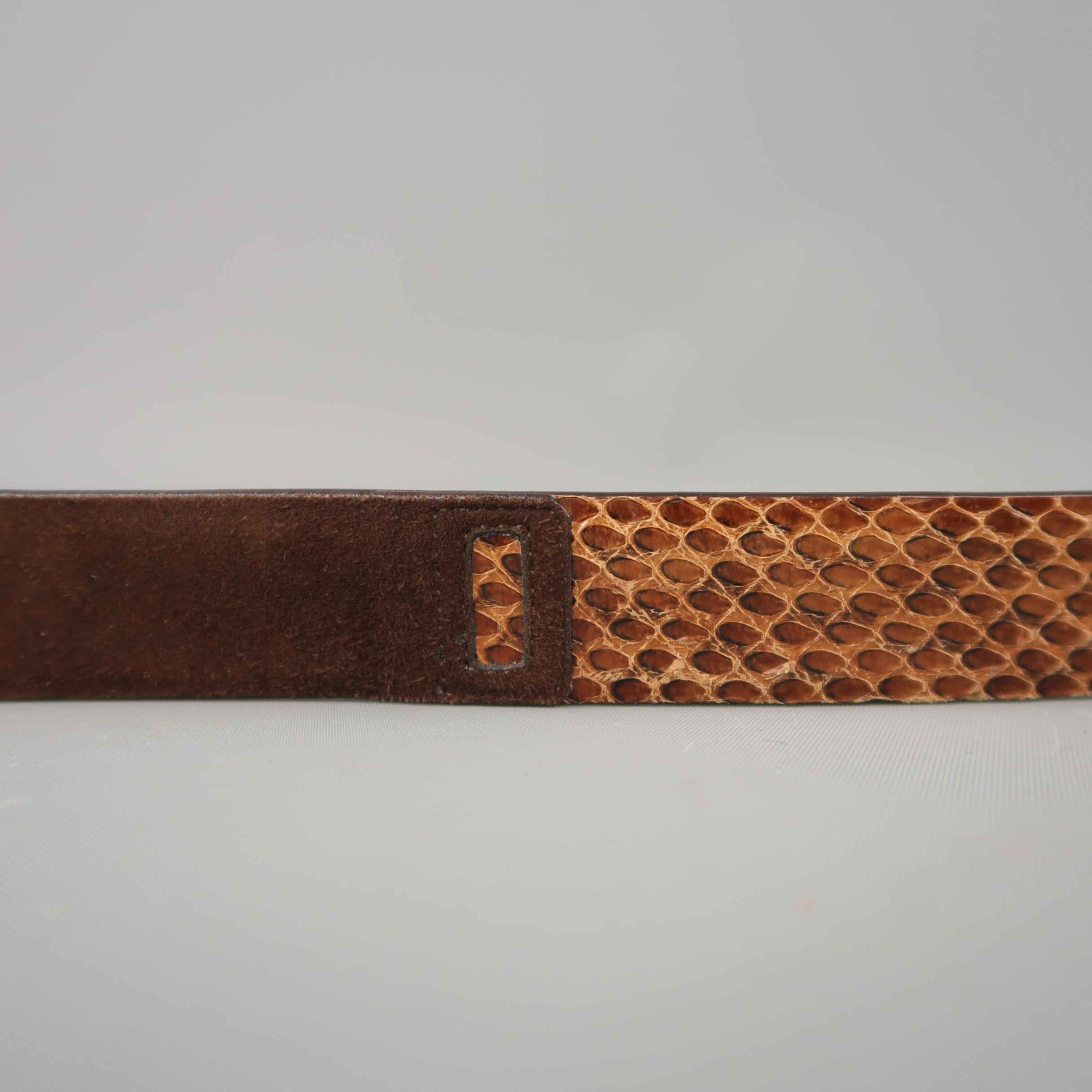DOLCE & GABBANA belt features a slit snakeskin and suede material strap with a gold tone embossed buckle. Wear throughout. As-is. Made in Italy.
 
Good Pre-Owned Condition.
Marked: 90 cm - 36 in.
 
Length: 41 in.
Width: 1 in.
Fits: 33- 37 in.