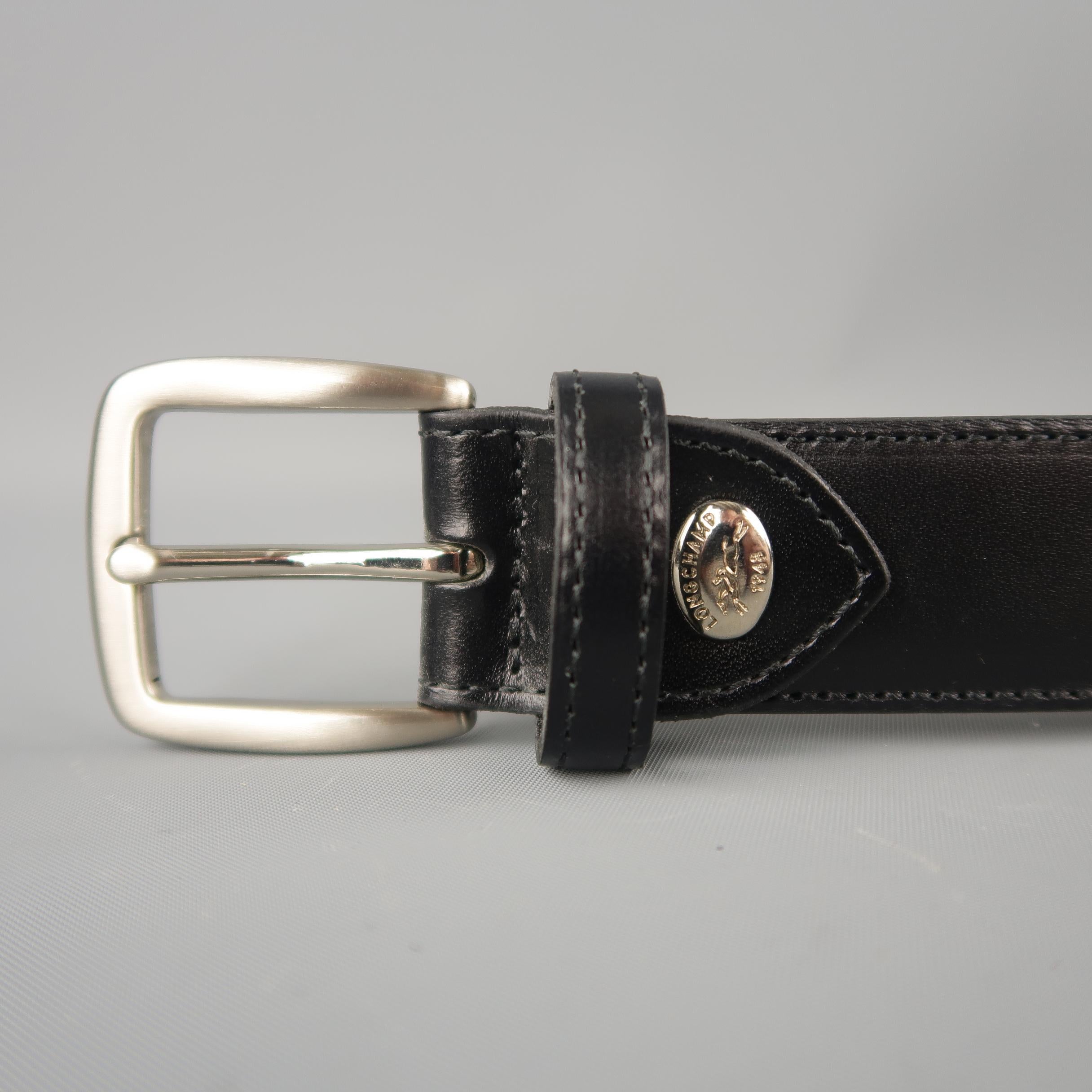 LONGCHAMP dress belt features a  black  leather strap with a silver tone buckle and logo plaque. Made in France.
 
Brand New.
Marked: (no size)
 
Length: 49 in.
Width: 1 in.
Fits: 42-46 in.