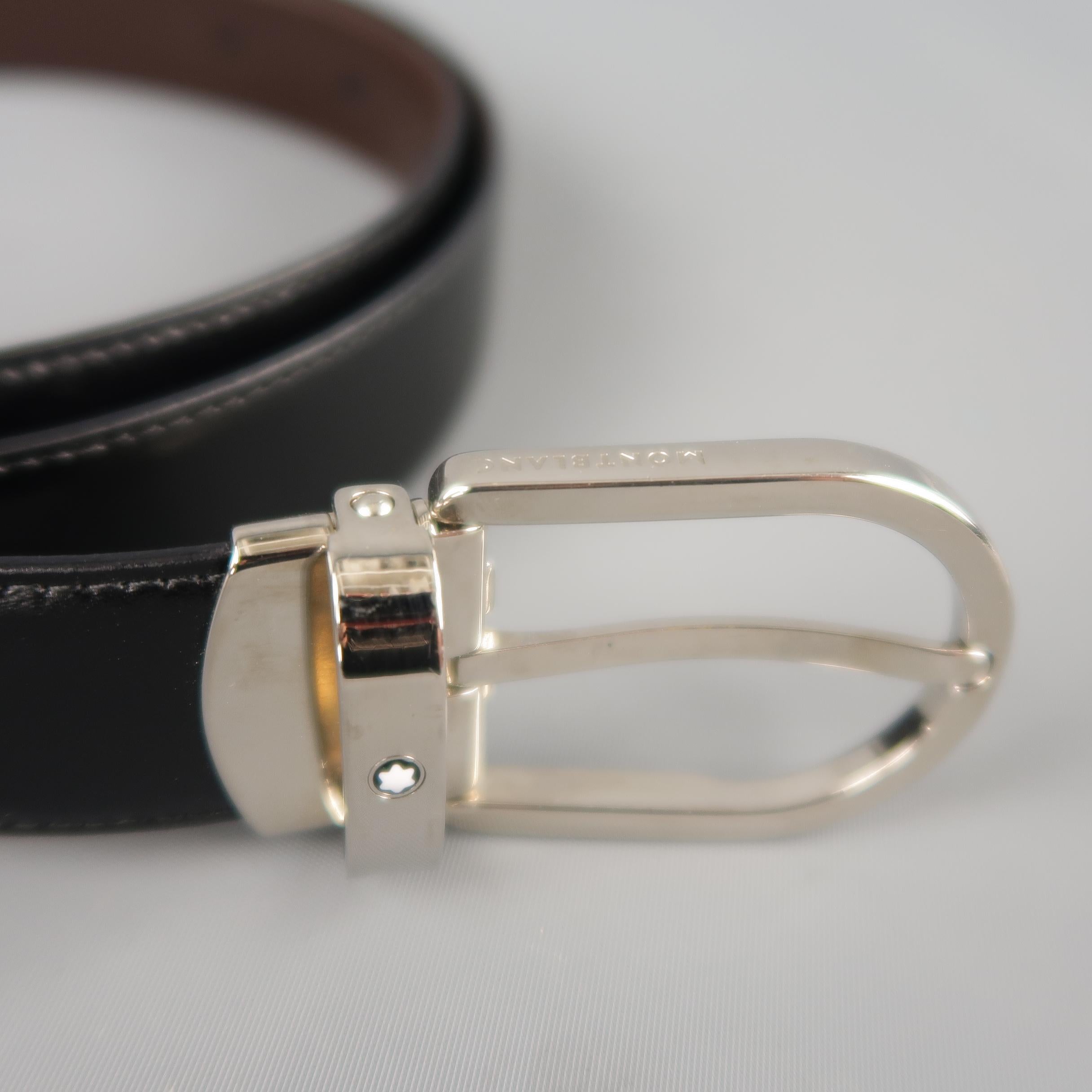MONT BLANC dress belt features a dual tone brown and black reversible leather strap with a silver tone D shaped buckle. Minor wear on buckle. Made in Italy.
 
Good Pre-Owned Condition.
Marked: (no size)
 
Length: 47 in.
Width: 1 in.
Fits: 38.5 -