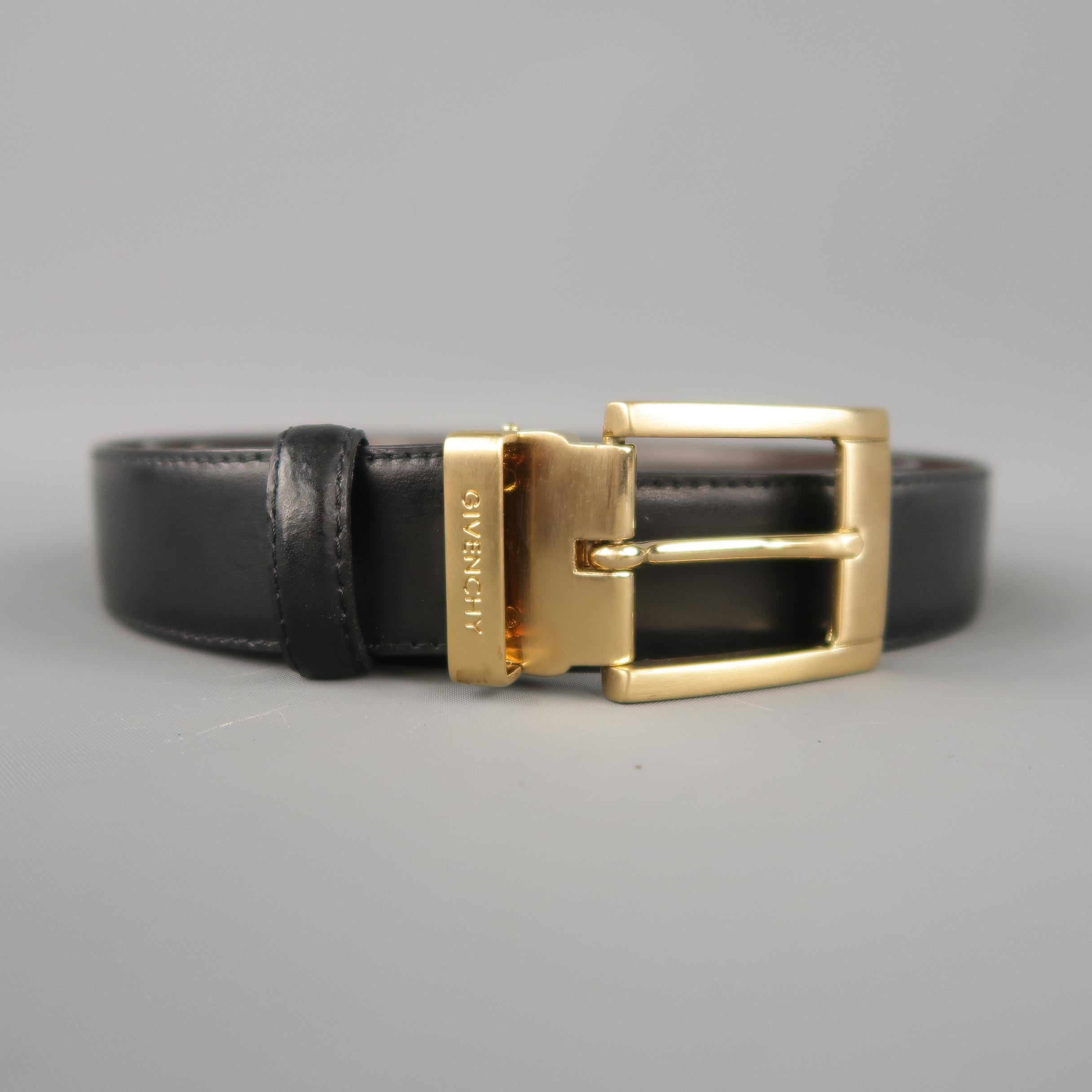 Vintage GIVENCHY dress belt features a dual tone brown and black reversible leather strap with a Gold tone metal buckle. Includes tags and both color loops. Made in Italy.
 
New with Tags.
Marked: (no size)
 
Length: 49 in.
Width: 1 in.
Fits: 41-45