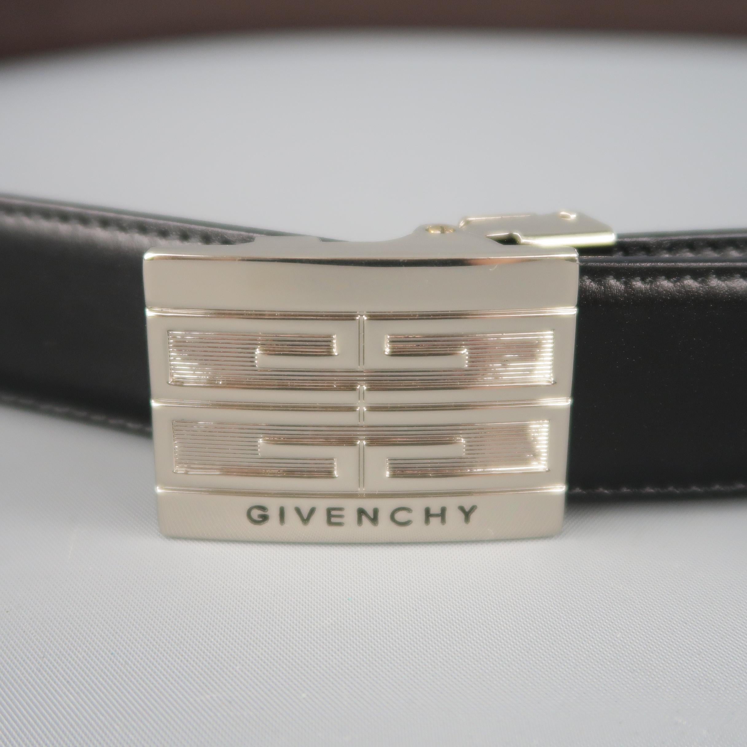 GIVENCHY dress belt features a dual tone brown and black reversible clamp closure strap with silver tone rectangular logo embossed buckle. Made in Italy.
 
New with Tags.
Marked: (no size)
 
Length: 50 in.
Width: 1 in.
Fits: Up to 46 in.