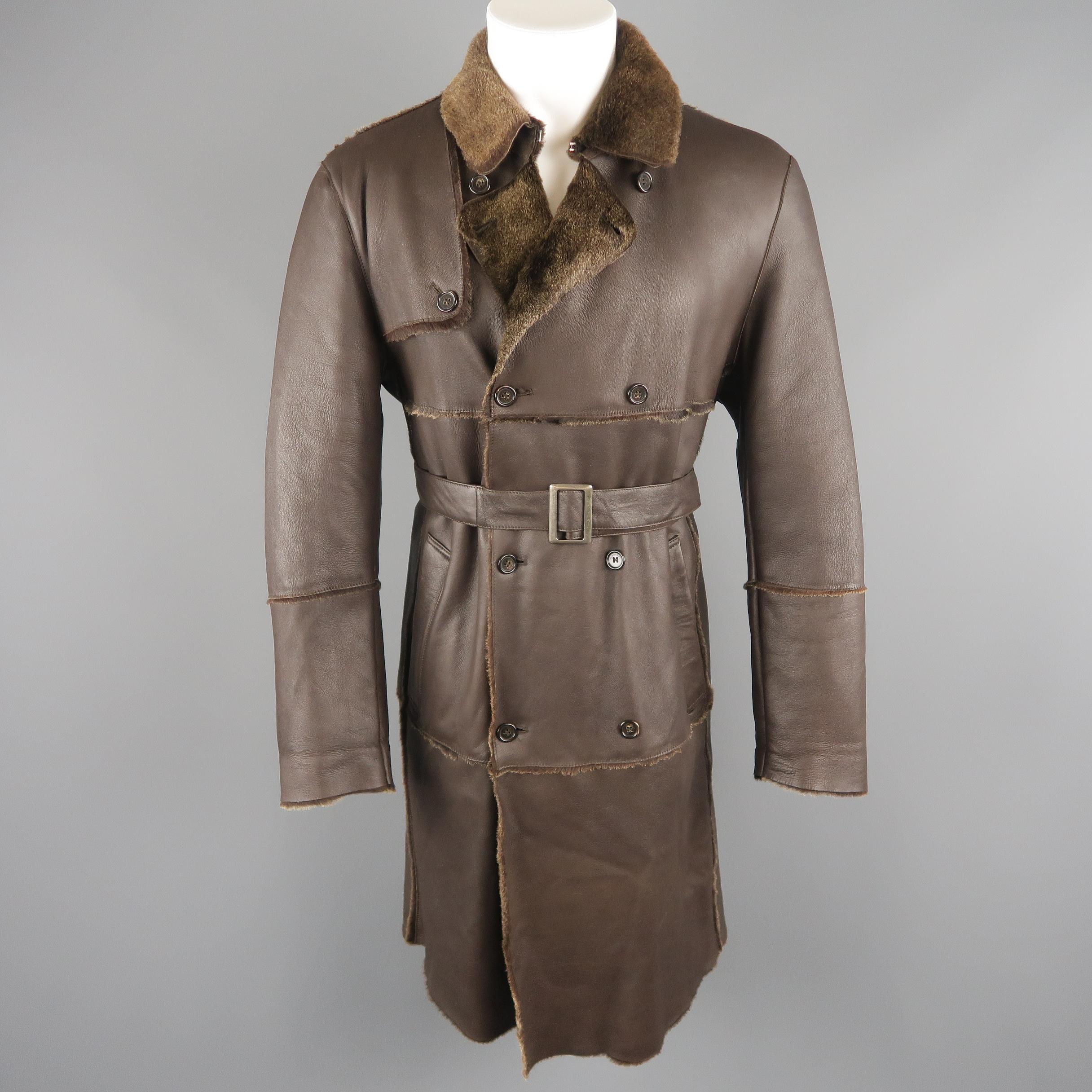 Burberry London trench coat comes in rich brown lamb skin shearling with trimmed fur interior and features a pointed hood eye closure collar, storm flap, double breasted button front, slanted pockets, and belted waist. Made in Italy.
 
Excellent
