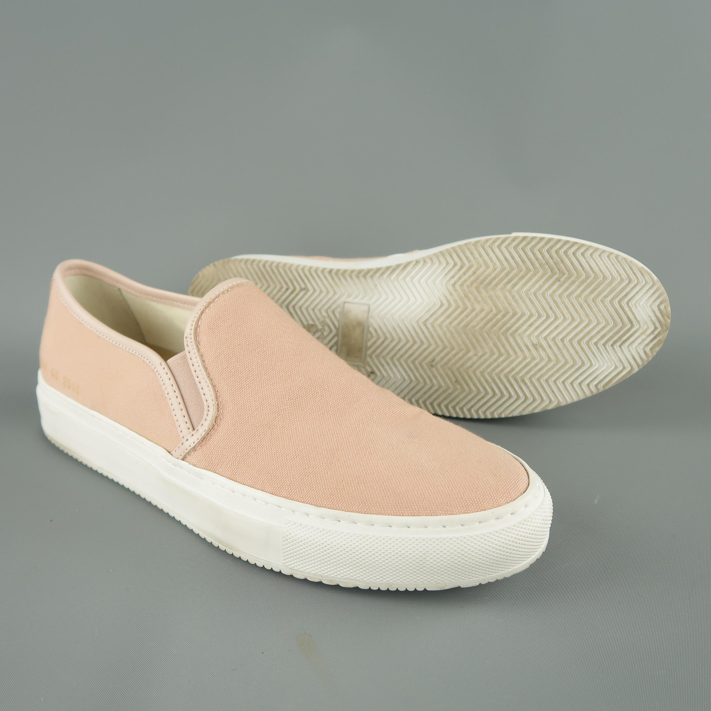 COMMON PROJECTS low top slip on sneakers come in rose pink canvas with tonal leather piping, gold flake marked heel, and white rubber sole. Minor wear.Made in Italy.
 
Good Pre-Owned Condition.
Marked: IT 40