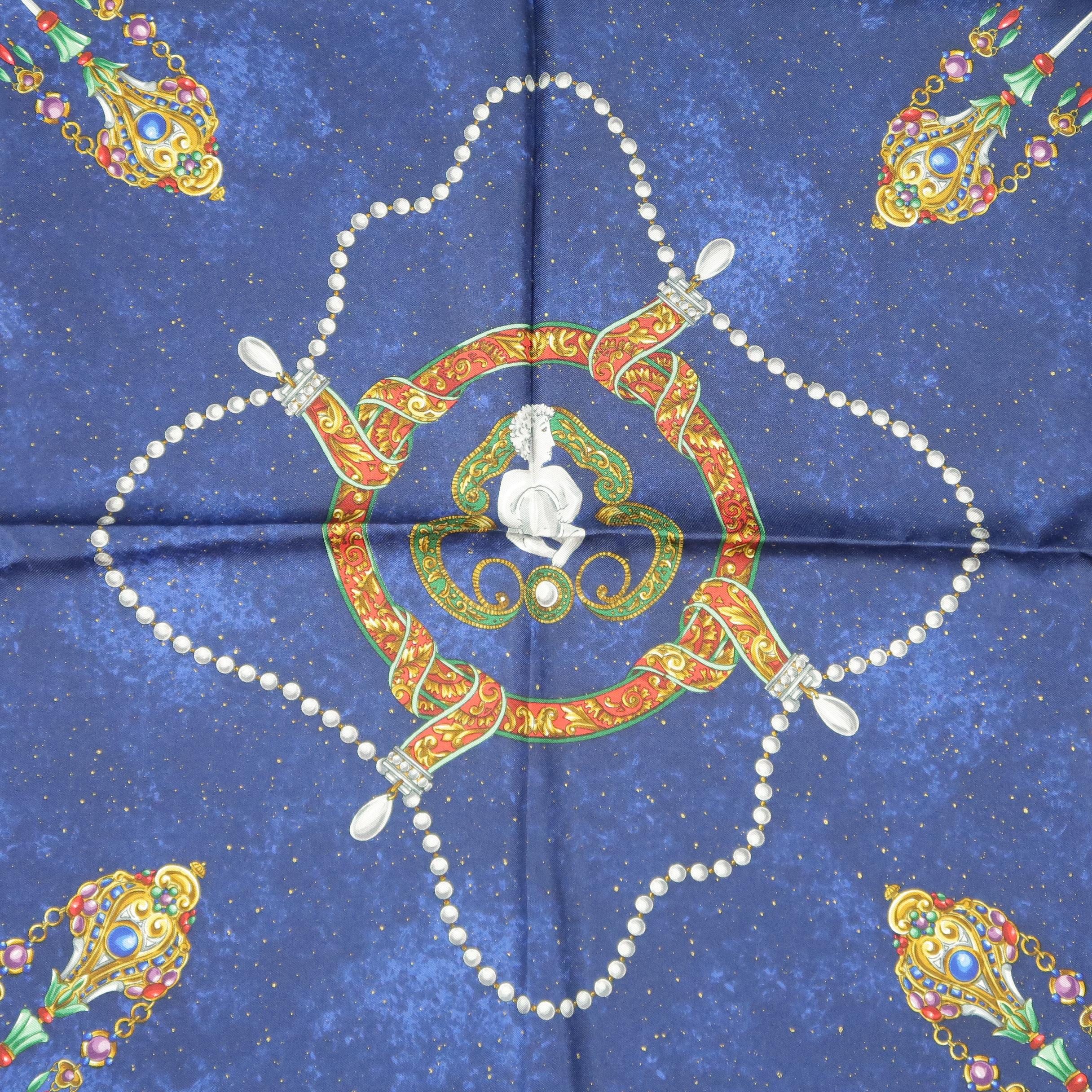 Vintage BOTTEGA VENETA scarf comes in a navy blue night sky print silk scarf with an all over abstract print featuring pearl and jeweled crowns and jewelry with angel motifs. Original I.Magnin tag attached. Made in Italy.
 
New with Tags.
 
88 x 88