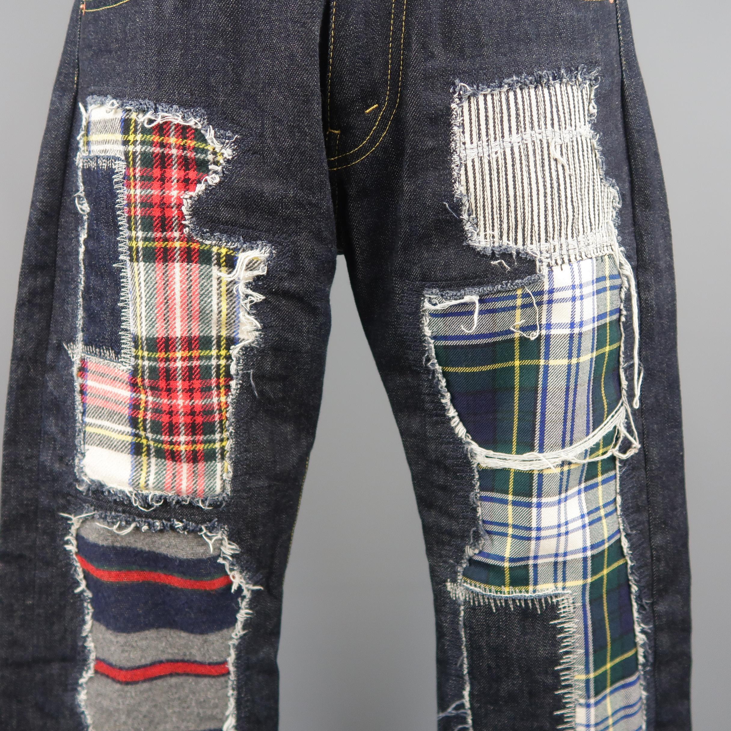 JUNYA WATANABE jeans come in classic dark indigo raw denim with distressed plaid patchwork details. AD 2014. Made in Japan.
 
Excellent Pre-Owned Condition.
Marked: S
 
Measurements:
 
Waist: 30
Rise: 10 in.
Inseam: 28 in.
