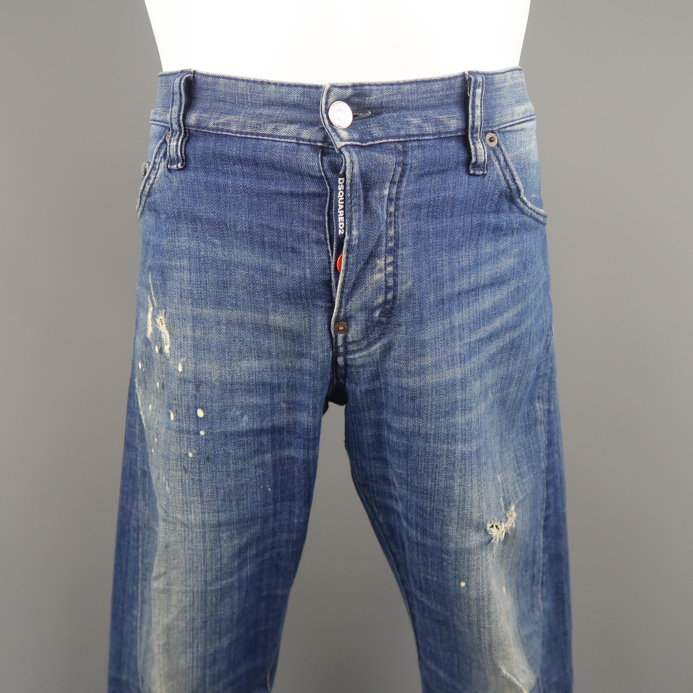 DSQUARED slim fit jeans come in medium dirty wash distressed denim with paint splatter details. Made in Italy.
 
Good Pre-Owned Condition.
Marked: IT 50
 
Measurements:
 
Waist: 36 in.
Rise: 9.5 in.
Inseam: 31 in.