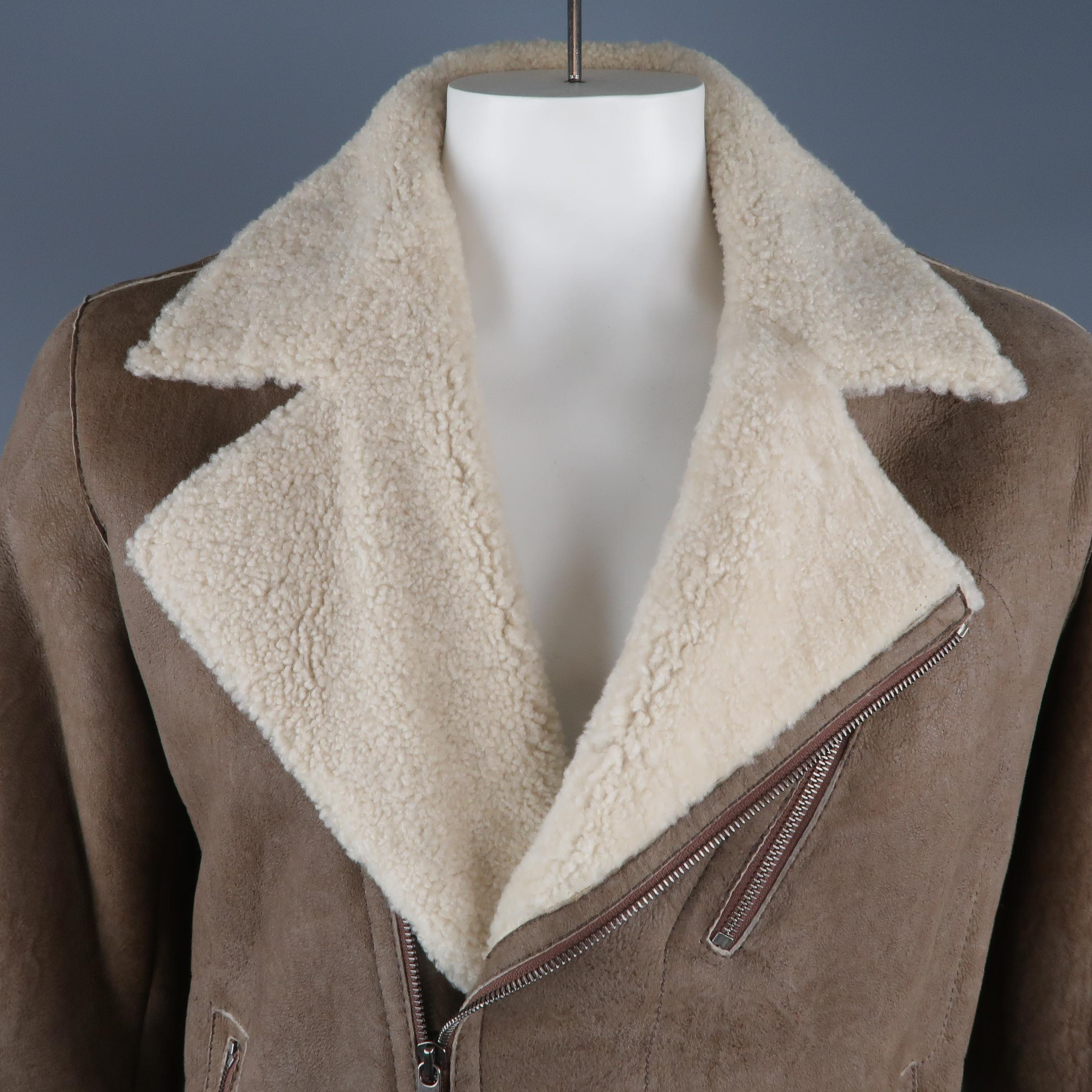 ZEGNA SPORT biker style jacket comes in tape distressed shearling with a cream fur lapel, asymmetrical zip closure, snap cuffs, and zip pockets.
 
Excellent Pre-Owned Condition.
Marked: L
 
Measurements:
 
Shoulder: 20 in.
Chest: 50 in.
Sleeve: 27