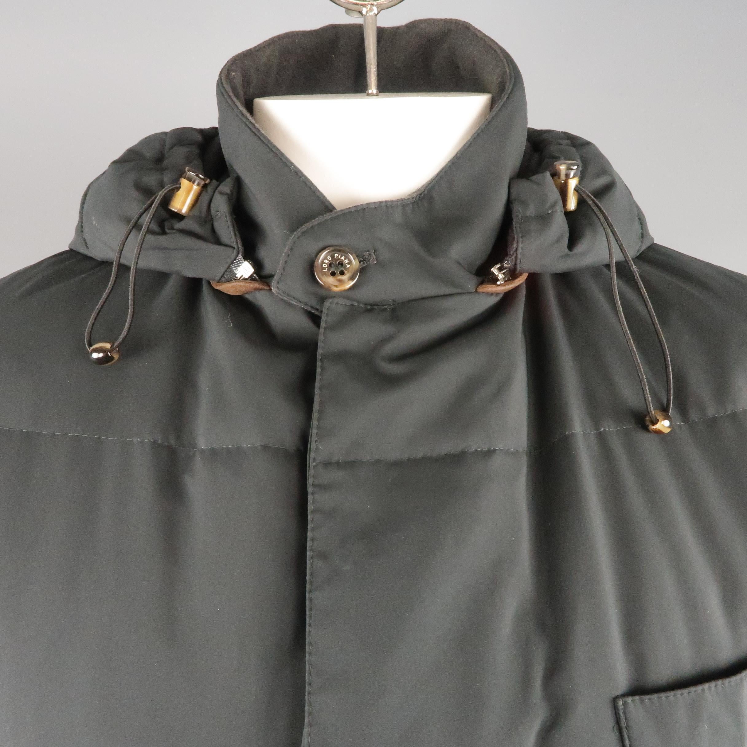LORO PIANA winter jacket comes in navy quilted down filled fabric with a high tab collar, zip closure with snap placket, patch flap pockets, and detachable hood. Made in Italy.
 
Excellent Pre-Owned Condition. Retails: $2,595.00.
Marked: L
