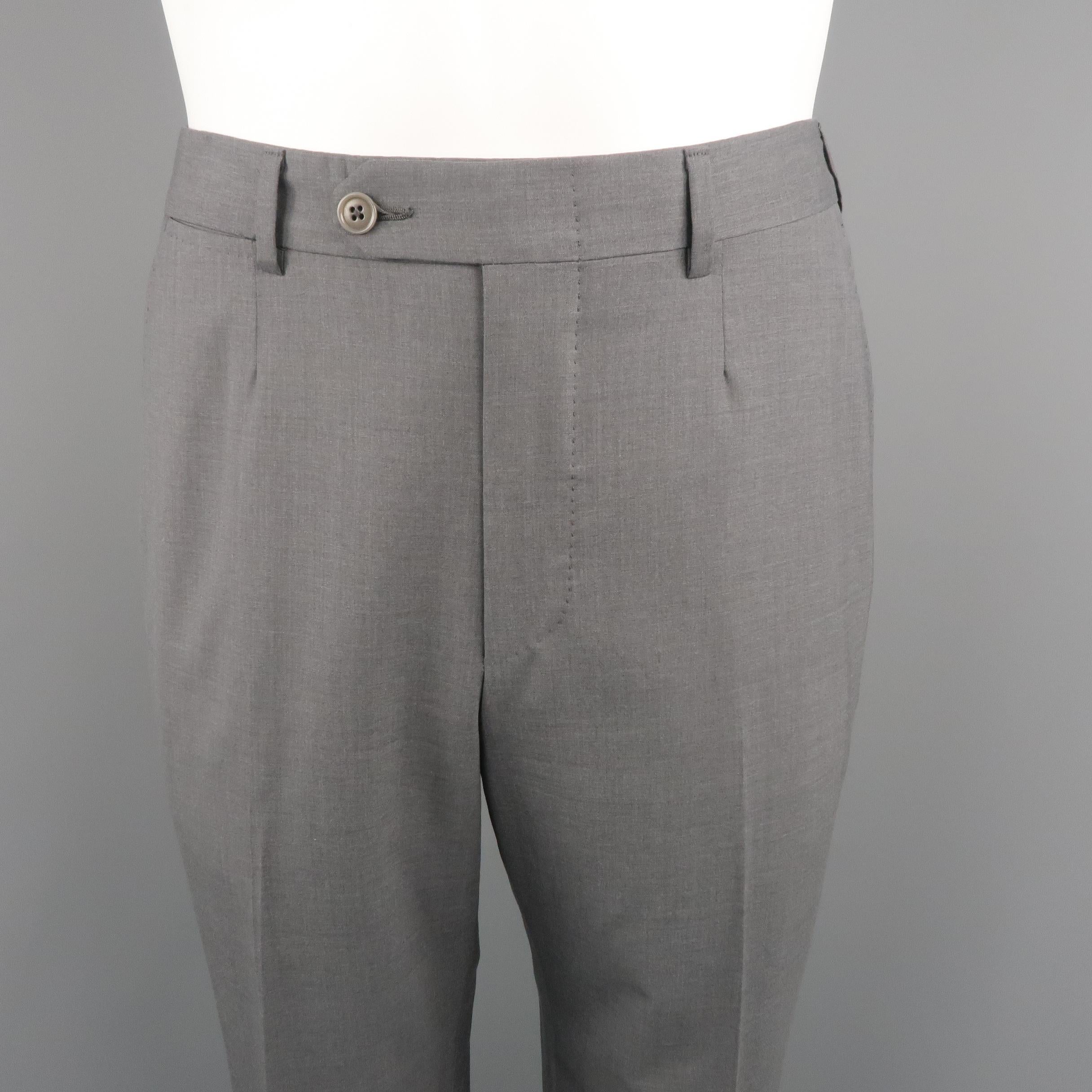 ERMENEGILDO ZEGNA dress pants come in dark gray tone in solid wool material with waistband, and slant side pockets. Made in Switzerland.
 
Excellent Pre-Owned Condition.
Marked: 7 - 48 R  IT
 
Measurements:
 
Waist: 33 in.
Rise: 10.5 in.
Inseam: 31