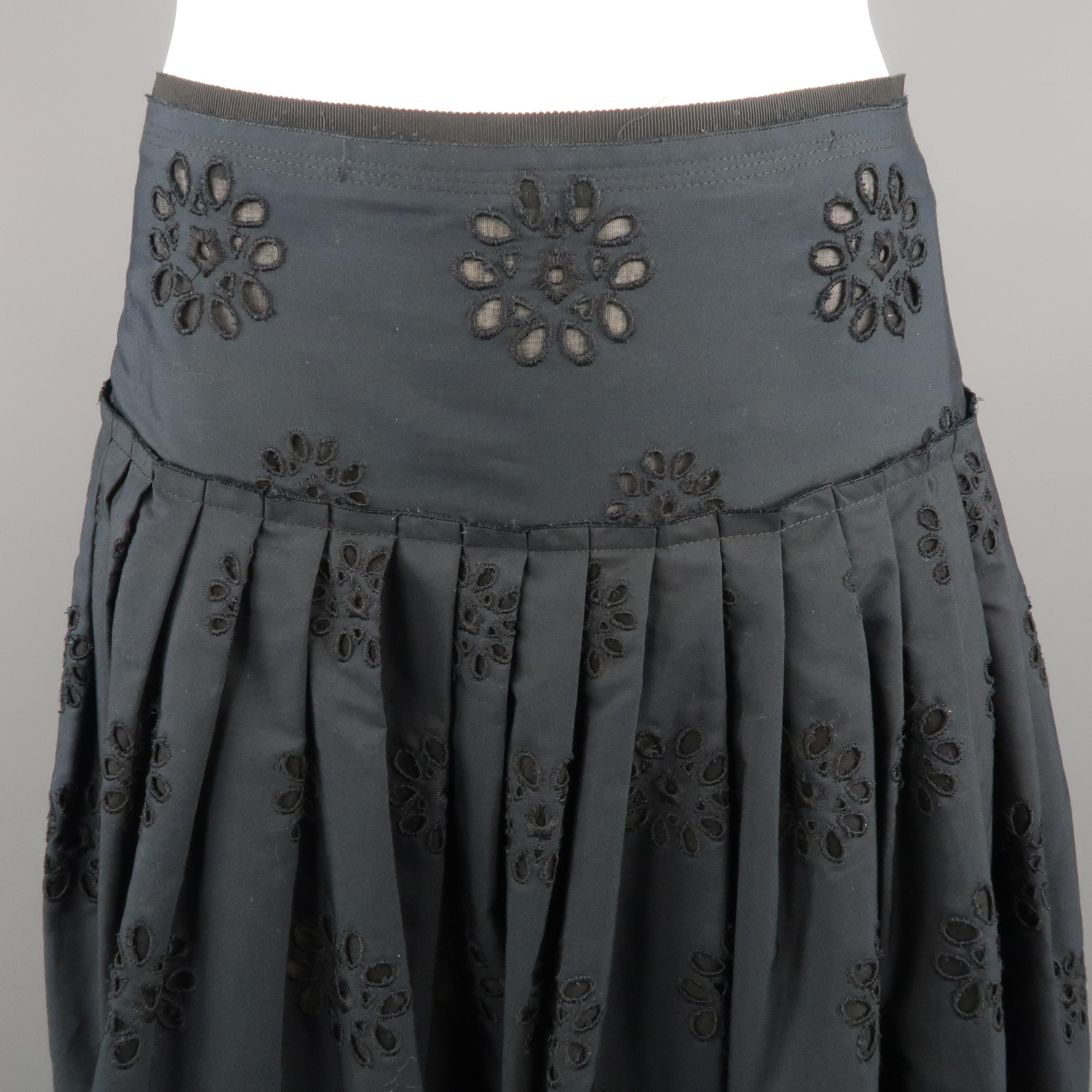 PRADA A-line skirt in a navy tone, cotton material, featuring eyelet embroidery and pleats on the top. Made in Italy.
 
Excellent Pre-Owned Condition.
Marked: 38 IT
 
Measurements:
 
Waist: 28 in.
Hip: 40 in.
Length: 27.5 in.