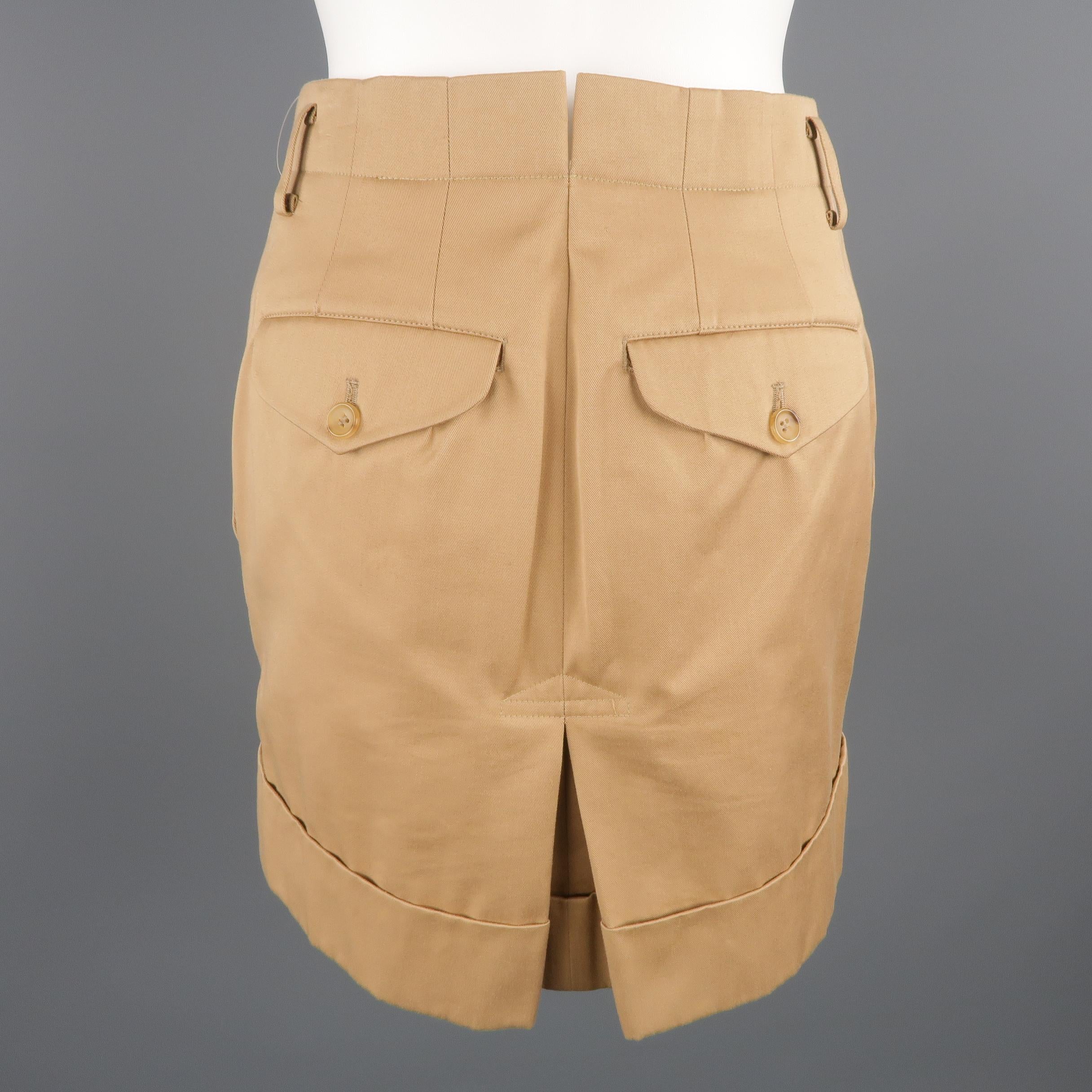 COMME des GARCONS mini skirt, comes  in a beige tone cotton / polyester material, featuring belt loops, pleats, and flap pockets on th back.  Made in Japan.
 
Excellent Pre-Owned Condition.
Marked: M
 
Measurements:
 
Waist: 30 in.
Hip: 36