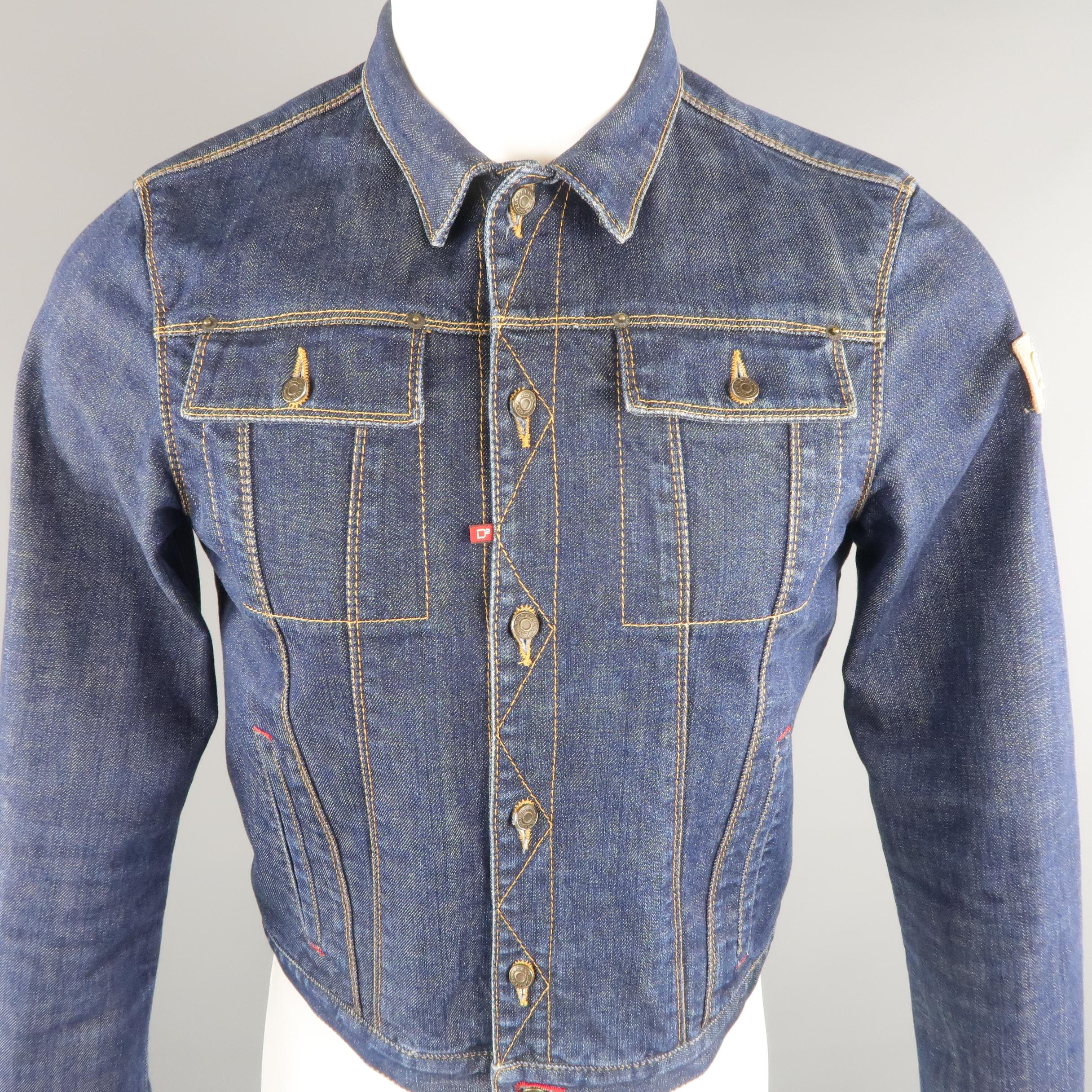 DSQUARED2 cropped jacket come in indigo denim, contrast stitches, patch flap pockets and lateral patch label. Made in Italy.
 
Excellent Pre-Owned Condition.
Marked: 48 IT
 
Measurements:
 
Shoulder: 15.5 in.
Chest: 38 in.
Sleeve: 27.5 in.
Length: