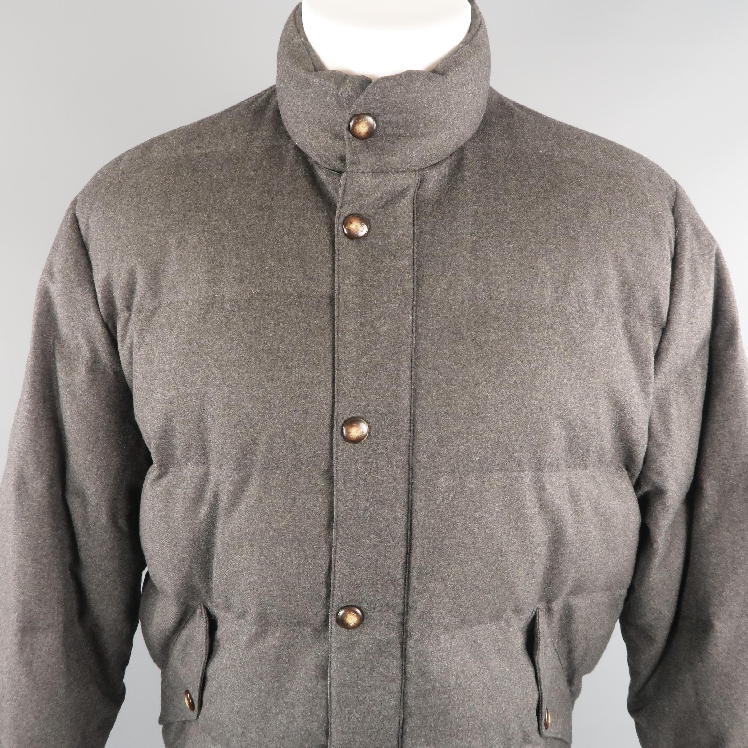 LORO PIANA puffer quilted  jacket come in charcoal tone in wool material, with flap pockets and adjusters on the cuffs. Made in Italy.
 
Excellent Pre-Owned Condition.
Marked: M
 
Measurements:
 
Shoulder: 20 in.
Chest: 100 in.
Sleeve: 25