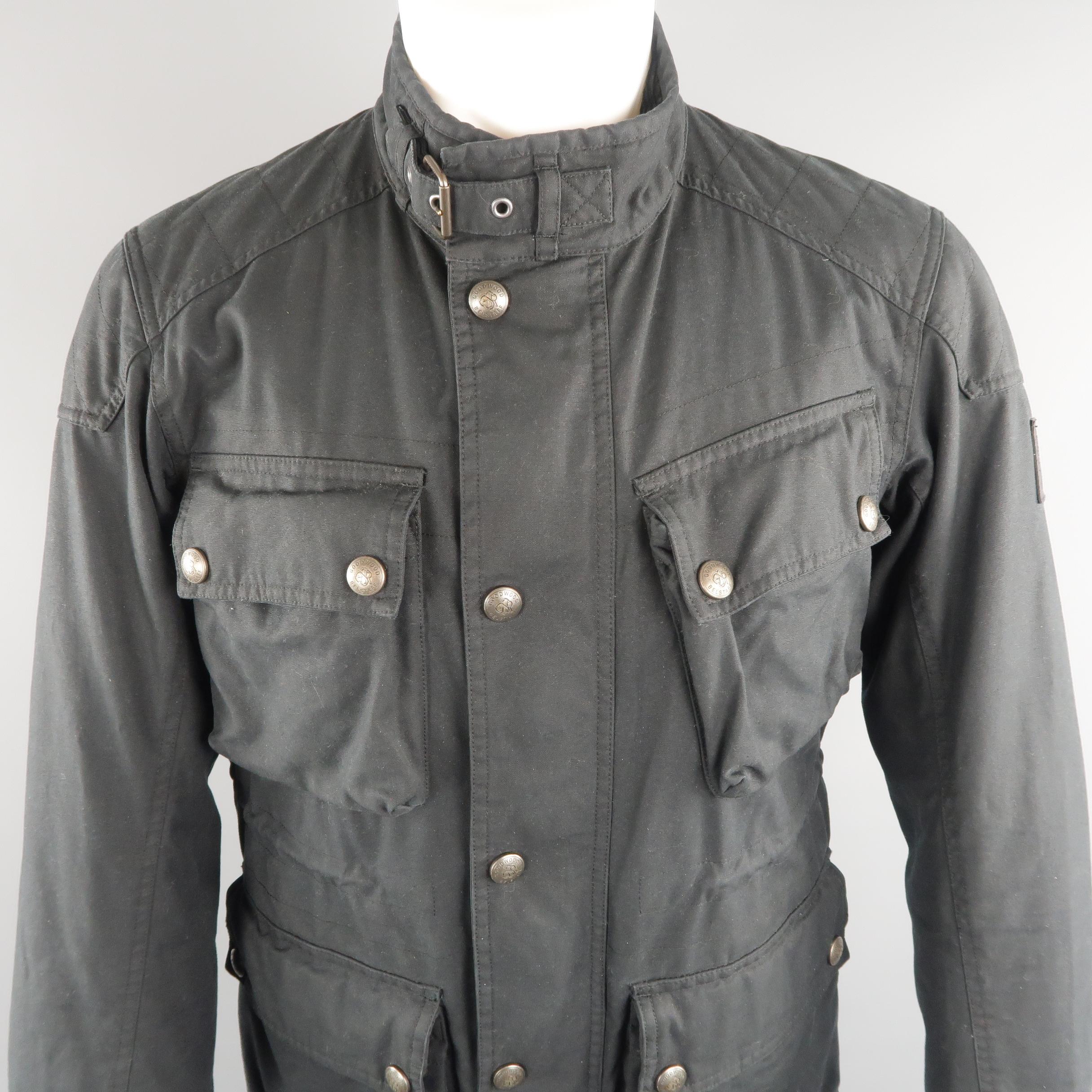 BELSTAFF goodwood sport and racing  jacket, come in black tone in solid cotton with multiple cargo pockets, patches, zip & snaps, belt and corduroy collar and lateral patched label.   
 
Good Pre-Owned Condition.
Marked: no size
 
Measurements:
