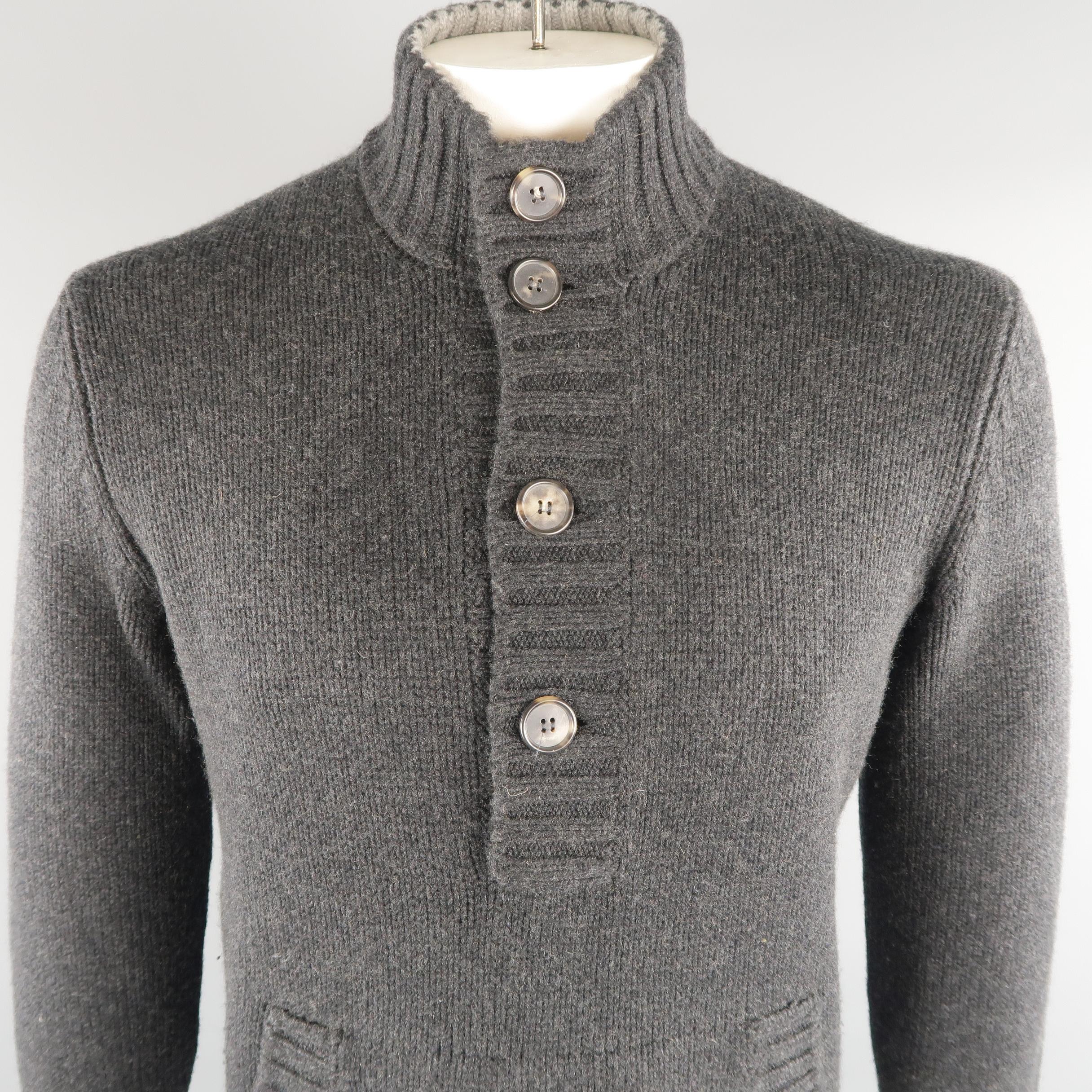 BRUNELLO CUCINELLI  henley sweater comes in 100% cashmere in a charcoal tone, knitted, with front pockets, ribbed cuffs and waistband. Made in Italy.
 
Excellent Pre-Owned Condition.
Marked: 52 IT
 
Measurements:
 
Shoulder: 17.5 in.
Chest: 45